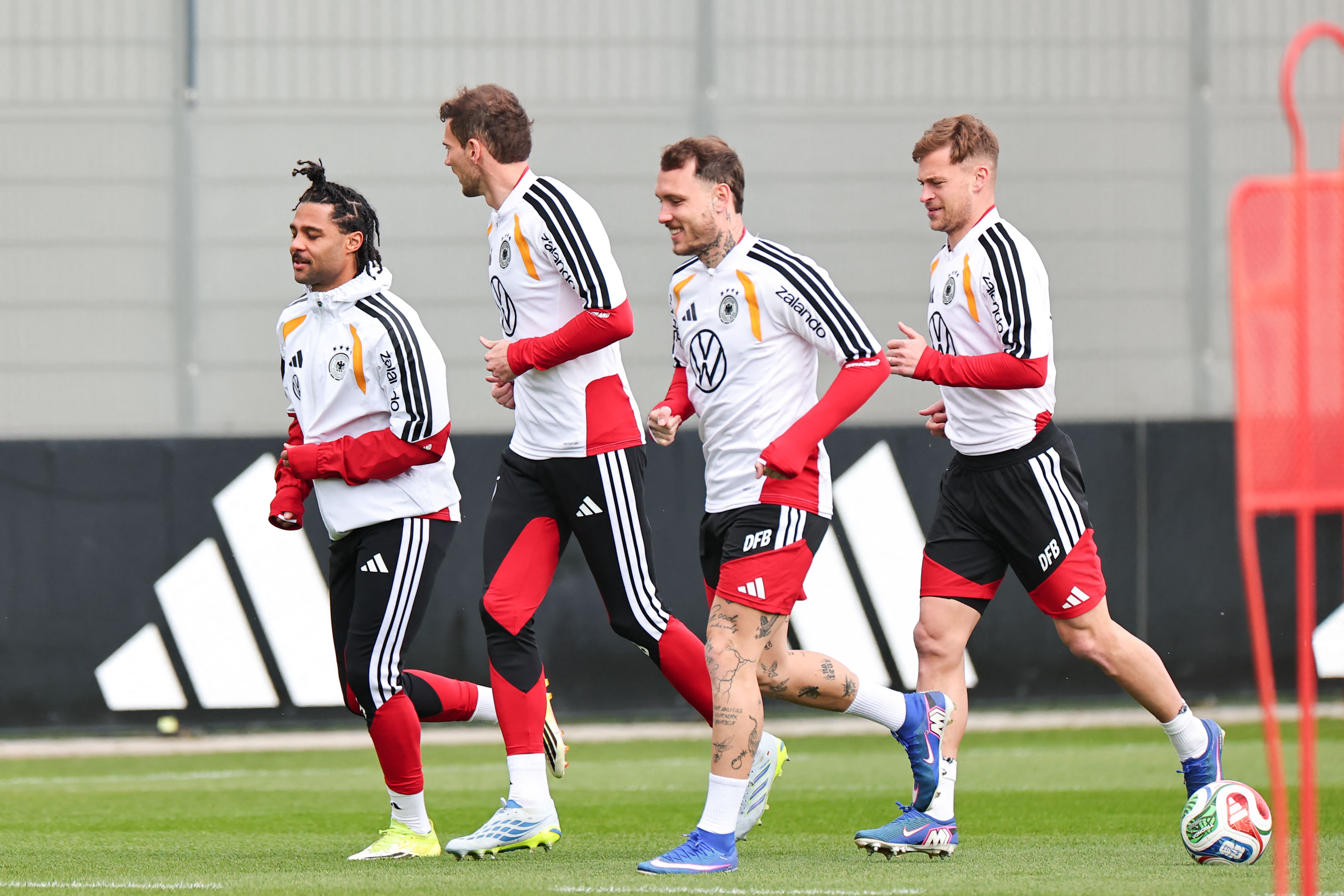 (L-R) Serge Germany's midfielder #20 Serge Gnabry, Germany's midfielder #08 Leon Goretzka, Germany's defender #22 David Raum and Germany's midfielder #06 Joshua Kimmich warm up during a training session before the international friendly footbal match against Switzerland in Herzogenaurach, southern Germany on March 26, 2026. (Photo by Daniel Karmann / AFP)