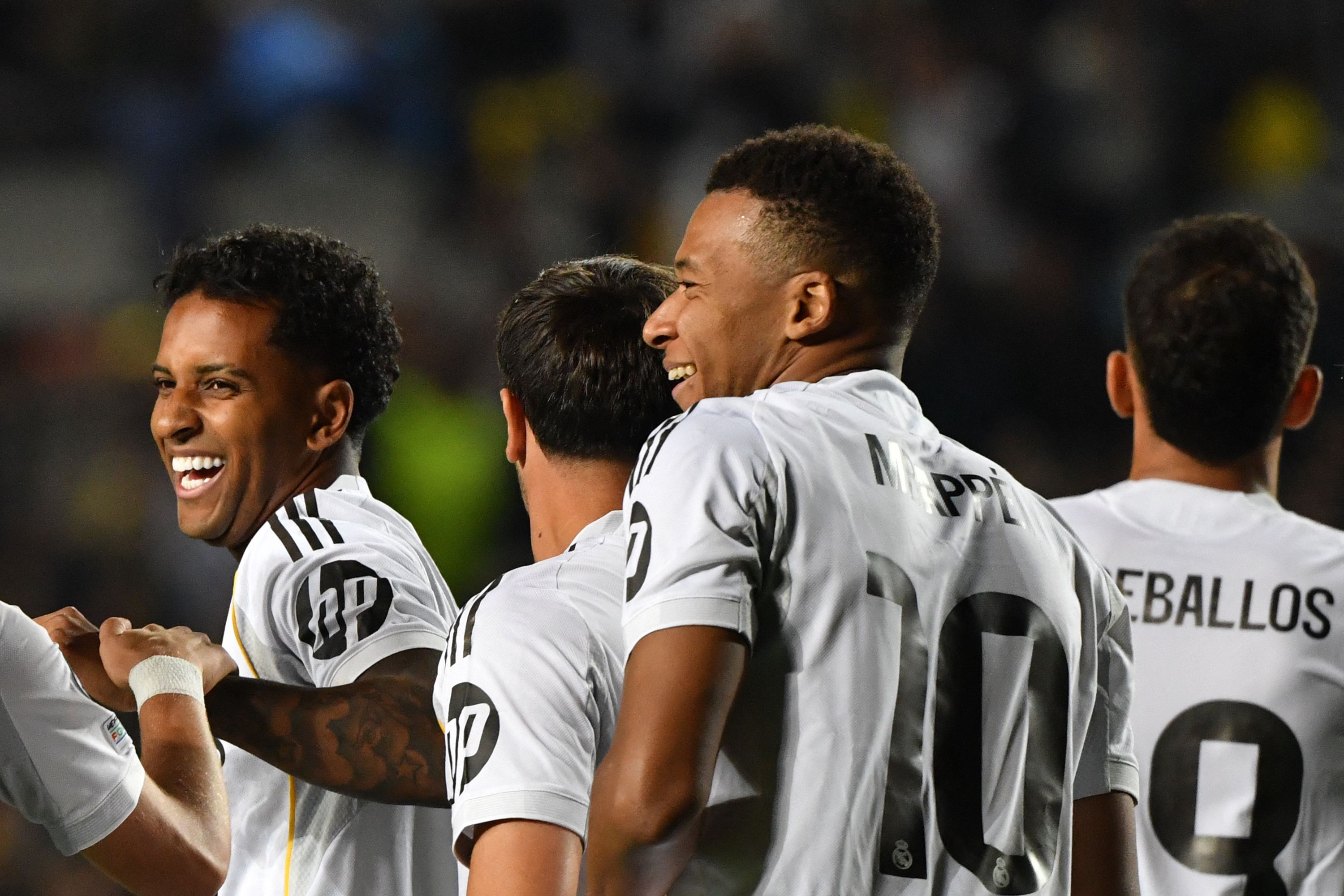 Real Madrid's French forward #10 Kylian Mbappe (R) celebrates scoring his team's third goal during the UEFA Champions League first round day 2 football match between Kairat Almaty and Real Madrid at the Almaty Ortalyk stadion in Almaty on September 30, 2025. (Photo by Vyacheslav OSELEDKO / AFP)