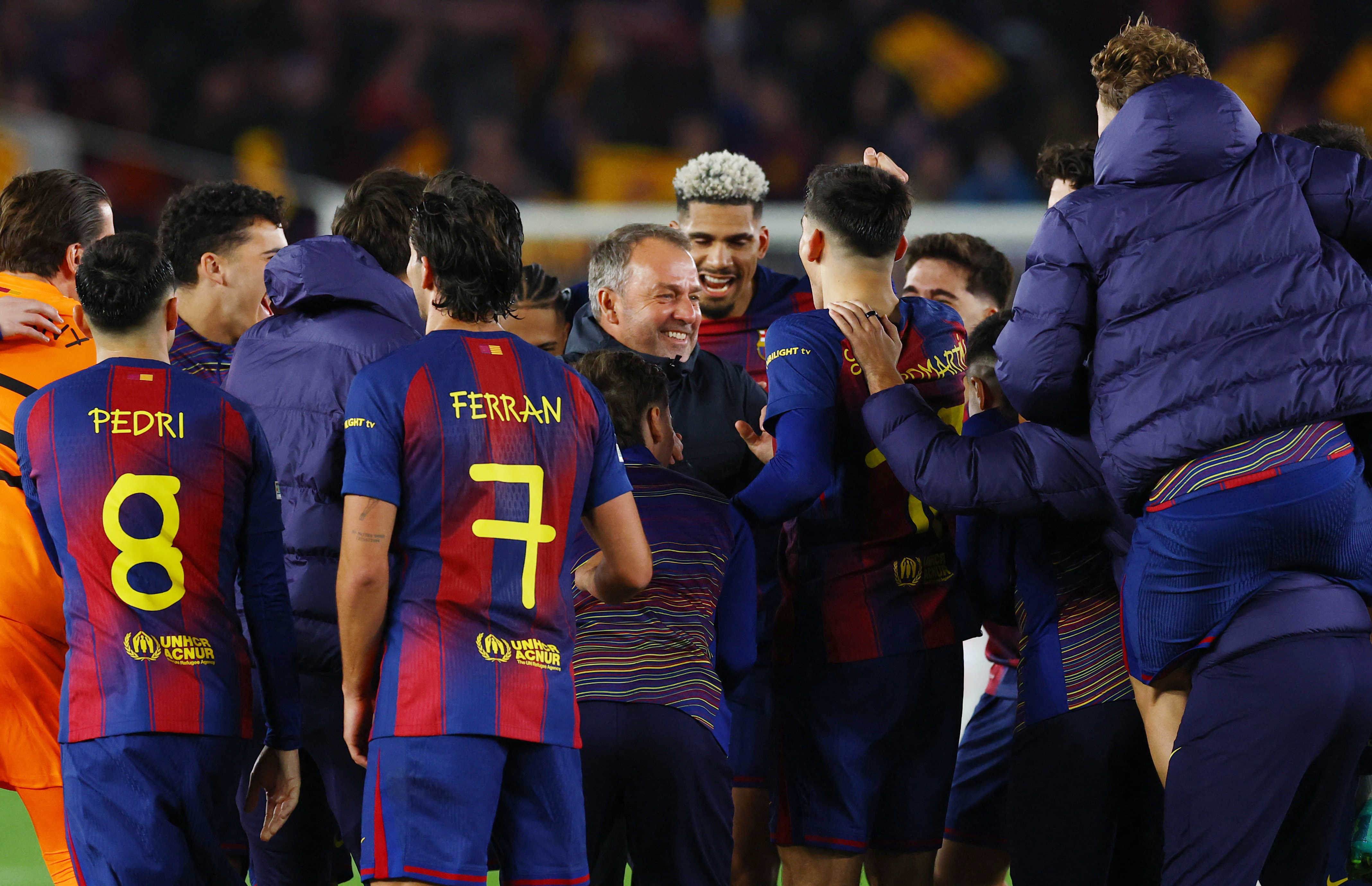 Soccer Football - UEFA Champions League - Round of 16 - Second Leg - FC Barcelona v Newcastle United - Spotify Camp Nou, Barcelona, Spain - March 18, 2026 FC Barcelona coach Hansi Flick celebrates with players after the match REUTERS/Albert Gea