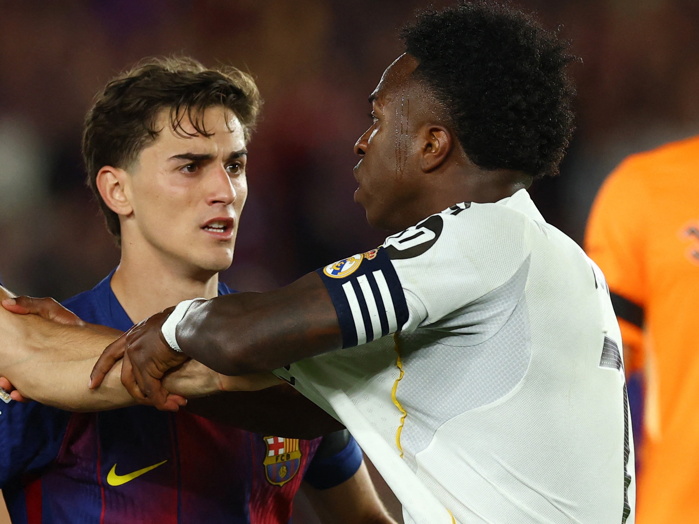 Soccer Football - LaLiga - FC Barcelona v Real Madrid - Spotify Camp Nou, Barcelona, Spain - May 10, 2026 Real Madrid's Vinicius Junior clashes with FC Barcelona's Dani Olmo, Gavi and Gerard Martin REUTERS/Albert Gea
