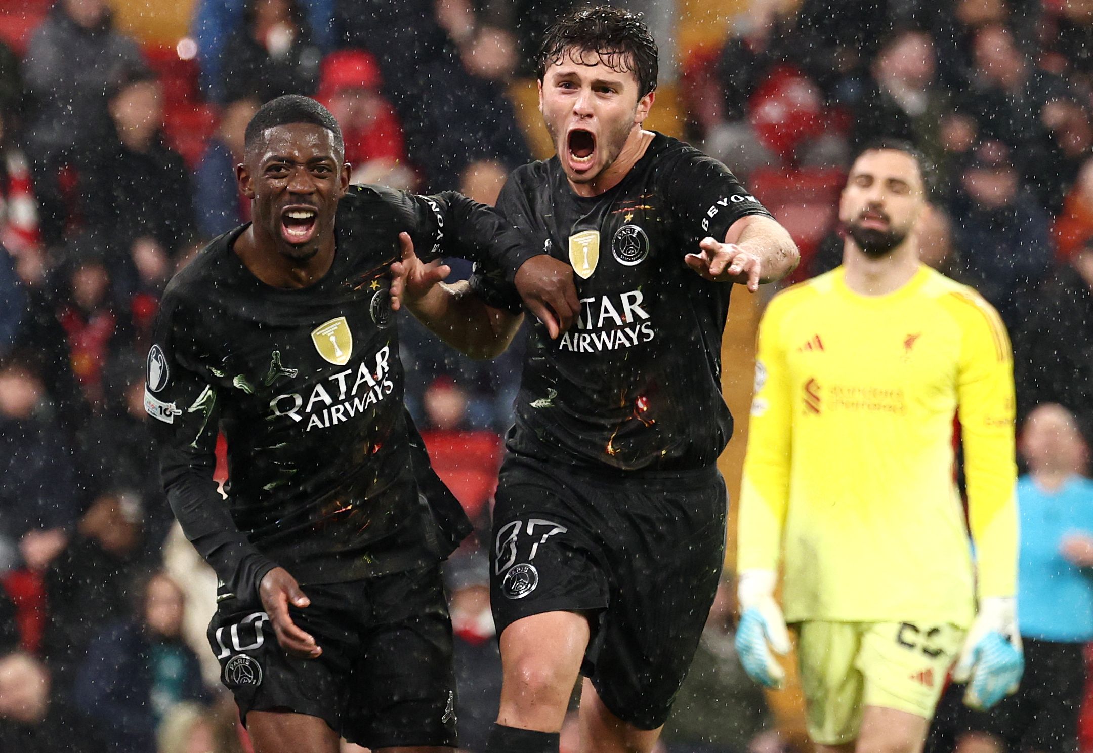 Paris Saint-Germain's French forward #10 Ousmane Dembele (L) celebrates scoring his team's second goal with Paris Saint-Germain's Portuguese midfielder #87 Joao Neves during the UEFA Champions League quarter final, second-leg football match between Liverpool and Paris Saint-Germain at Anfield in Liverpool, north west England on April 14, 2026. (Photo by FRANCK FIFE / AFP)