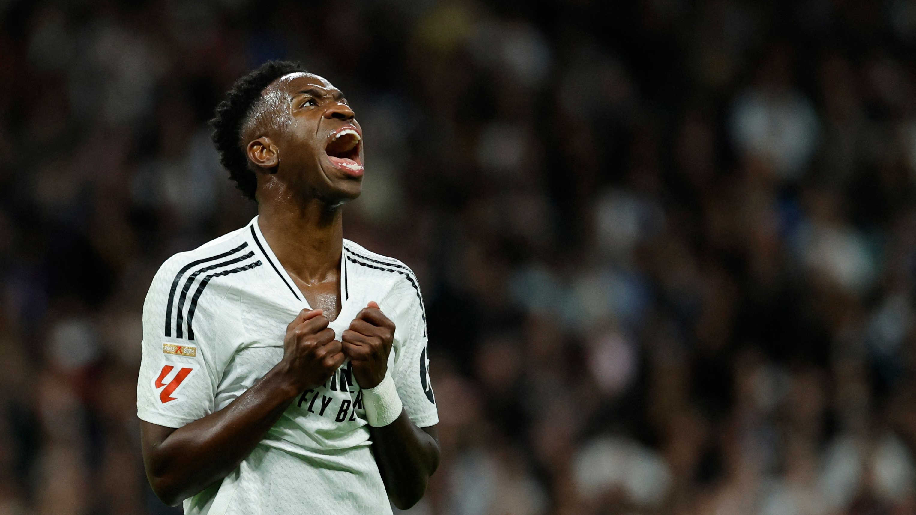 TOPSHOT - Real Madrid's Brazilian forward #07 Vinicius Junior reacts during the Spanish league football match between Real Madrid CF and FC Barcelona at the Santiago Bernabeu stadium in Madrid on October 26, 2024. (Photo by OSCAR DEL POZO / AFP)