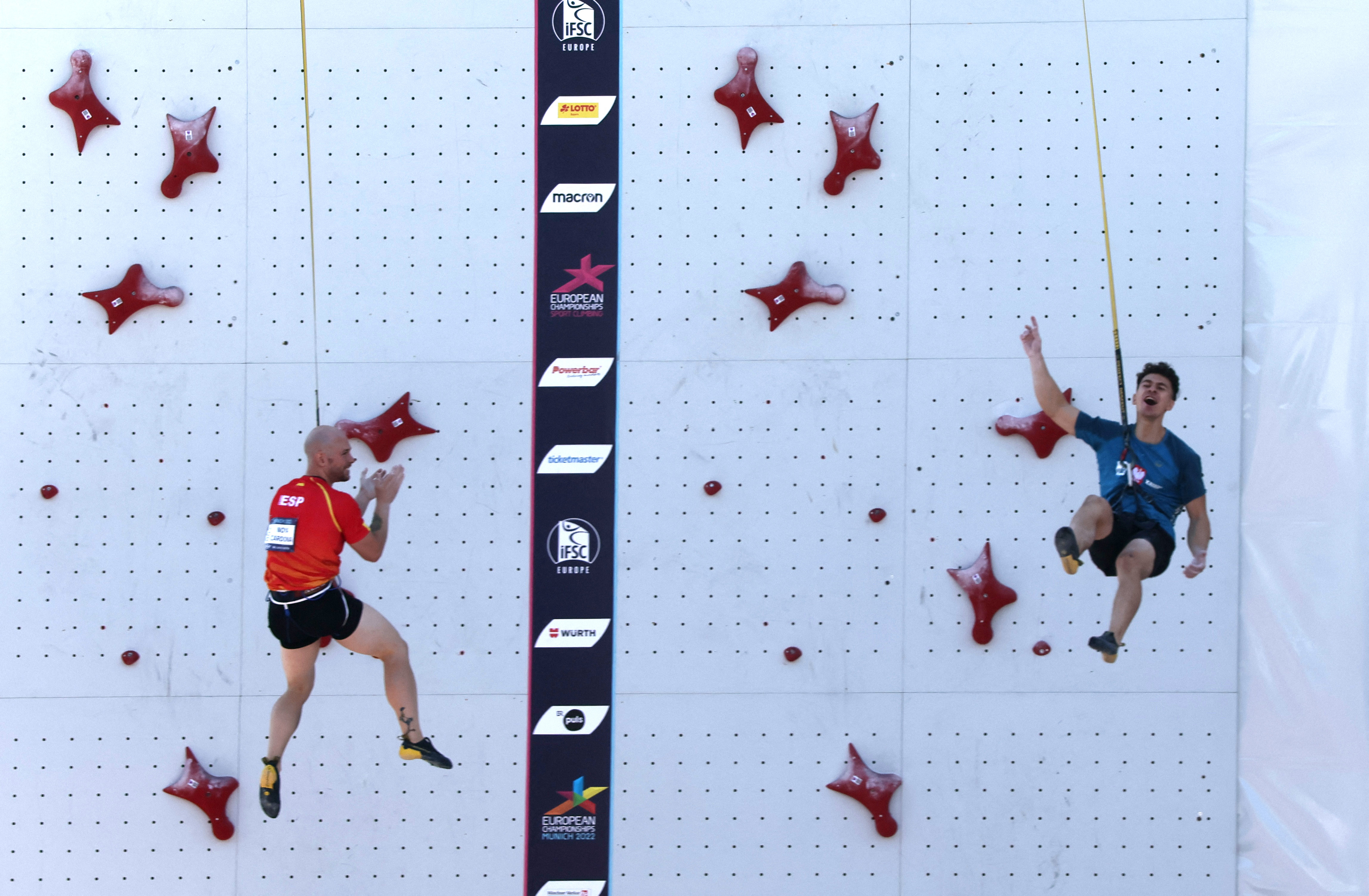 2022 European Championships - Sport Climbing - Konigsplatz, Munich, Germany - August 15, 2022 Poland's Marcin Dzienski celebrates after winning his round against Spain's Erik Paulo Noya Cardon during the men's speed final REUTERS/Wolfgang Rattay