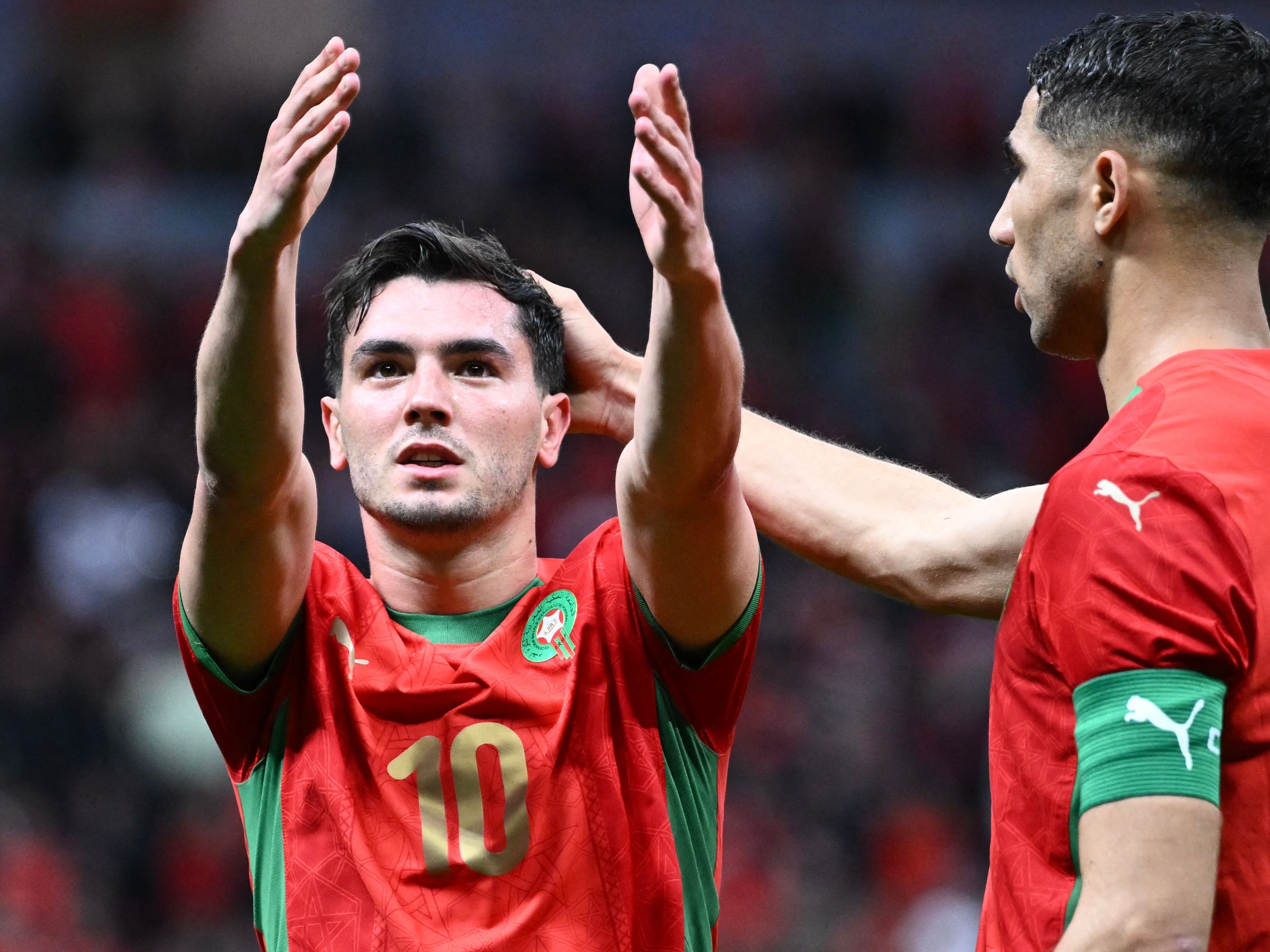 Morocco's forward #10 Brahim Diaz celebrates scoring his team's first goal next to Morocco's defender #02 Achraf Hakimi during the Africa Cup of Nations (CAN) round of 16 football match between Morocco and Tanzania at Prince Moulay Abdallah Stadium in Rabat on January 4, 2026. (Photo by SEBASTIEN BOZON / AFP)