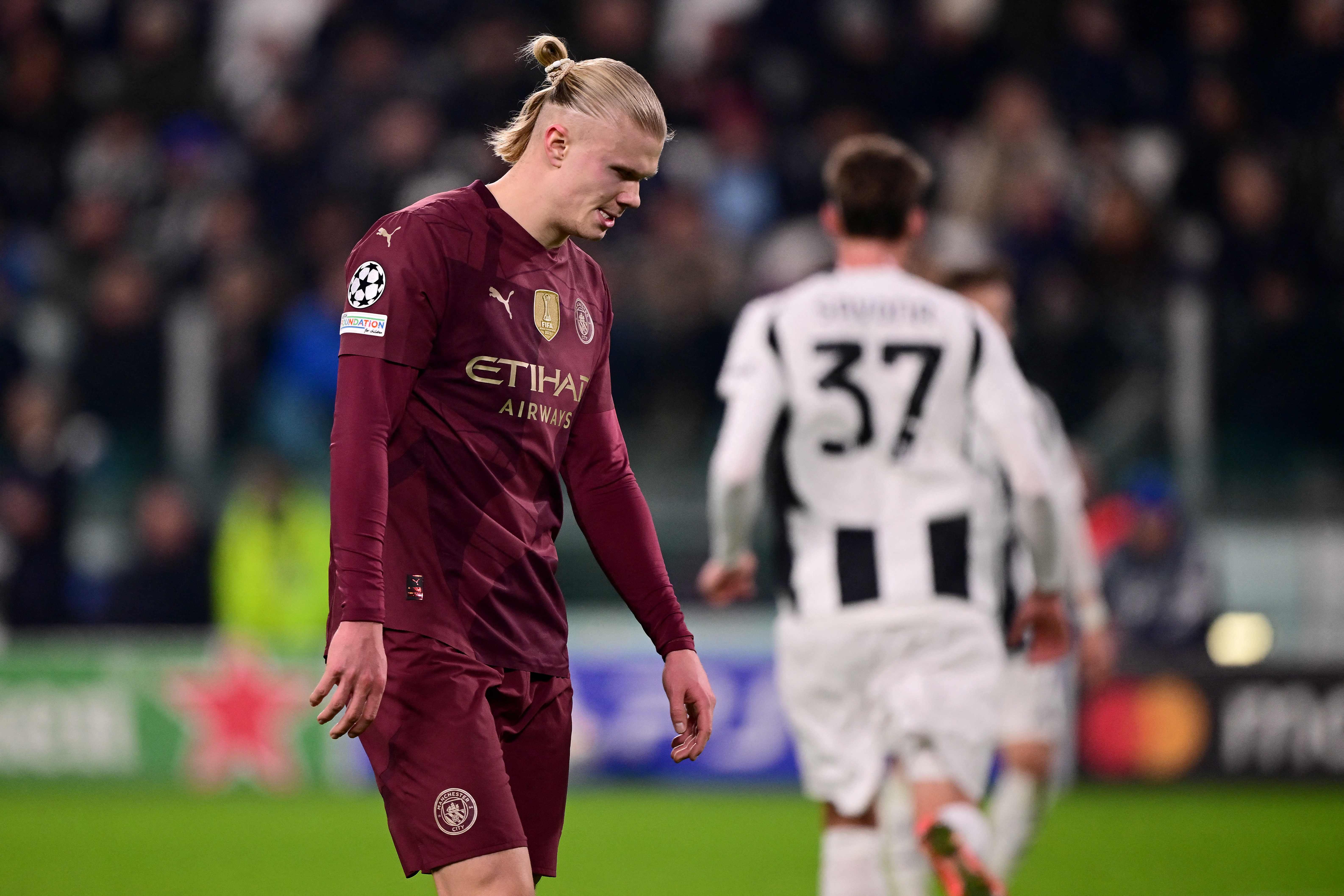 Manchester City's Norwegian forward #09 Erling Braut Haland (L) reacts during the UEFA Champions League, league phase day 6, football match between Juventus (ITA) and Manchester City (ENG) at the Allianz stadium in Turin, on December 11, 2024. (Photo by Marco BERTORELLO / AFP)