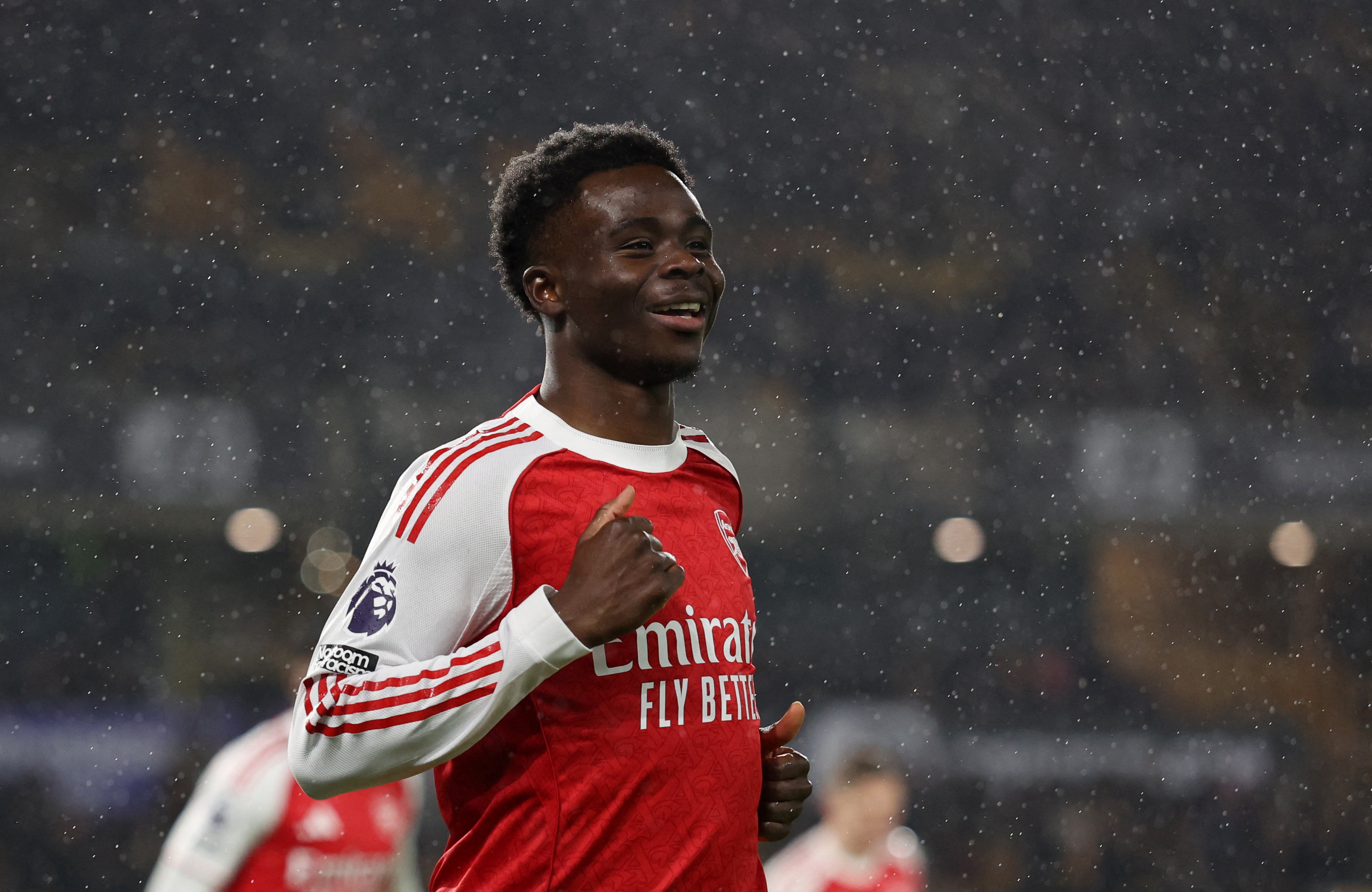 Soccer Football - Premier League - Wolverhampton Wanderers v Arsenal - Molineux Stadium, Wolverhampton, Britain - February 18, 2026 Arsenal's Bukayo Saka celebrates scoring their first goal REUTERS/Chris Radburn EDITORIAL USE ONLY. NO USE WITH UNAUTHORIZED AUDIO, VIDEO, DATA, FIXTURE LISTS, CLUB/LEAGUE LOGOS OR 'LIVE' SERVICES. ONLINE IN-MATCH USE LIMITED TO 120 IMAGES, NO VIDEO EMULATION. NO USE IN BETTING, GAMES OR SINGLE CLUB/LEAGUE/PLAYER PUBLICATIONS. PLEASE CONTACT YOUR ACCOUNT REPRESENTATIVE FOR FURTHER DETAILS..