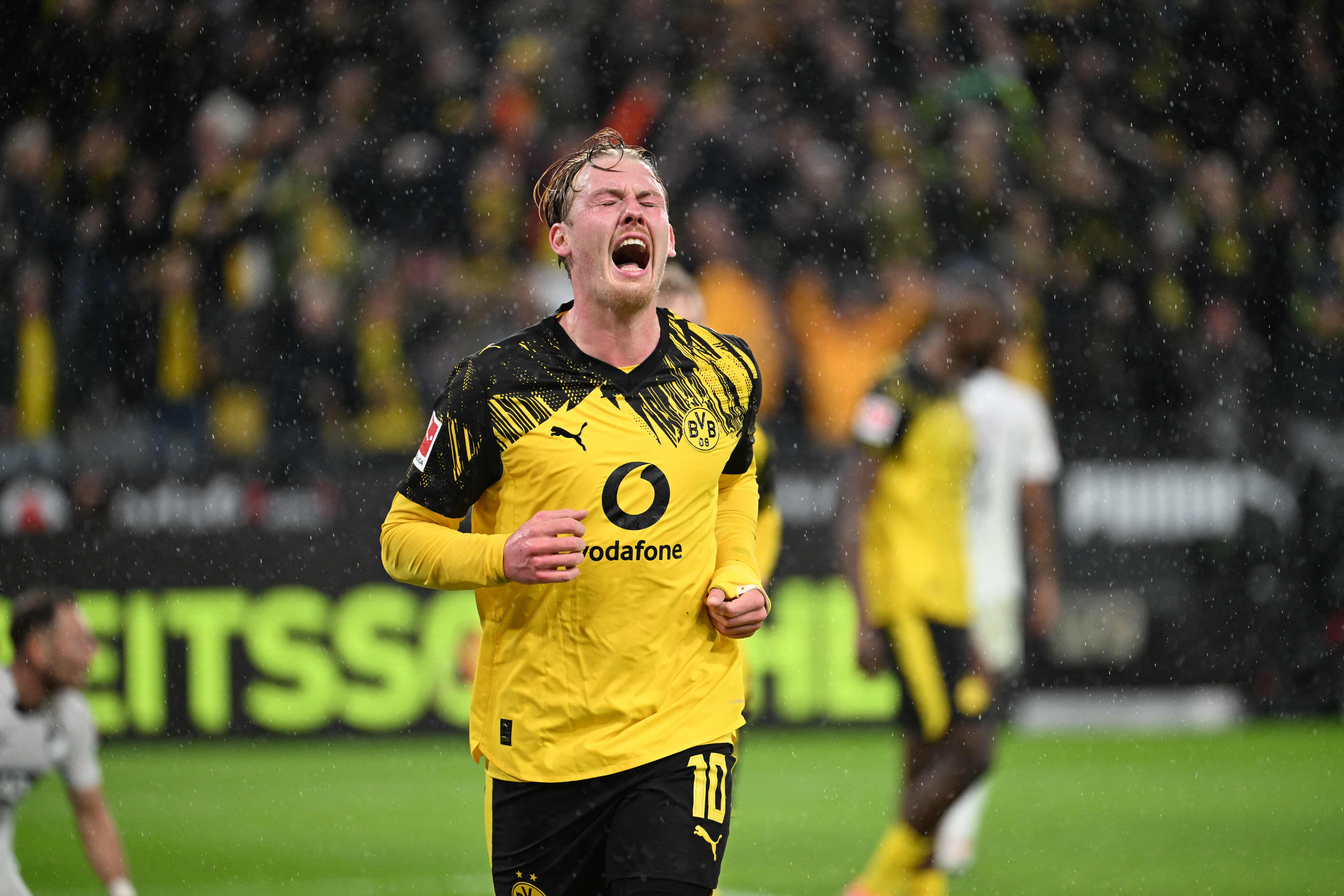 Dortmund's German midfielder #10 Julian Brandt celebrates after scoring the opening goal 0-1 during the German first division Bundesliga football match between BVB Borussia Dortmund and TSG 1899 Hoffenheim in Dortmund, western Germany, on December 7, 2025. (Photo by UWE KRAFT / AFP) / DFL REGULATIONS PROHIBIT ANY USE OF PHOTOGRAPHS AS IMAGE SEQUENCES AND/OR QUASI-VIDEO