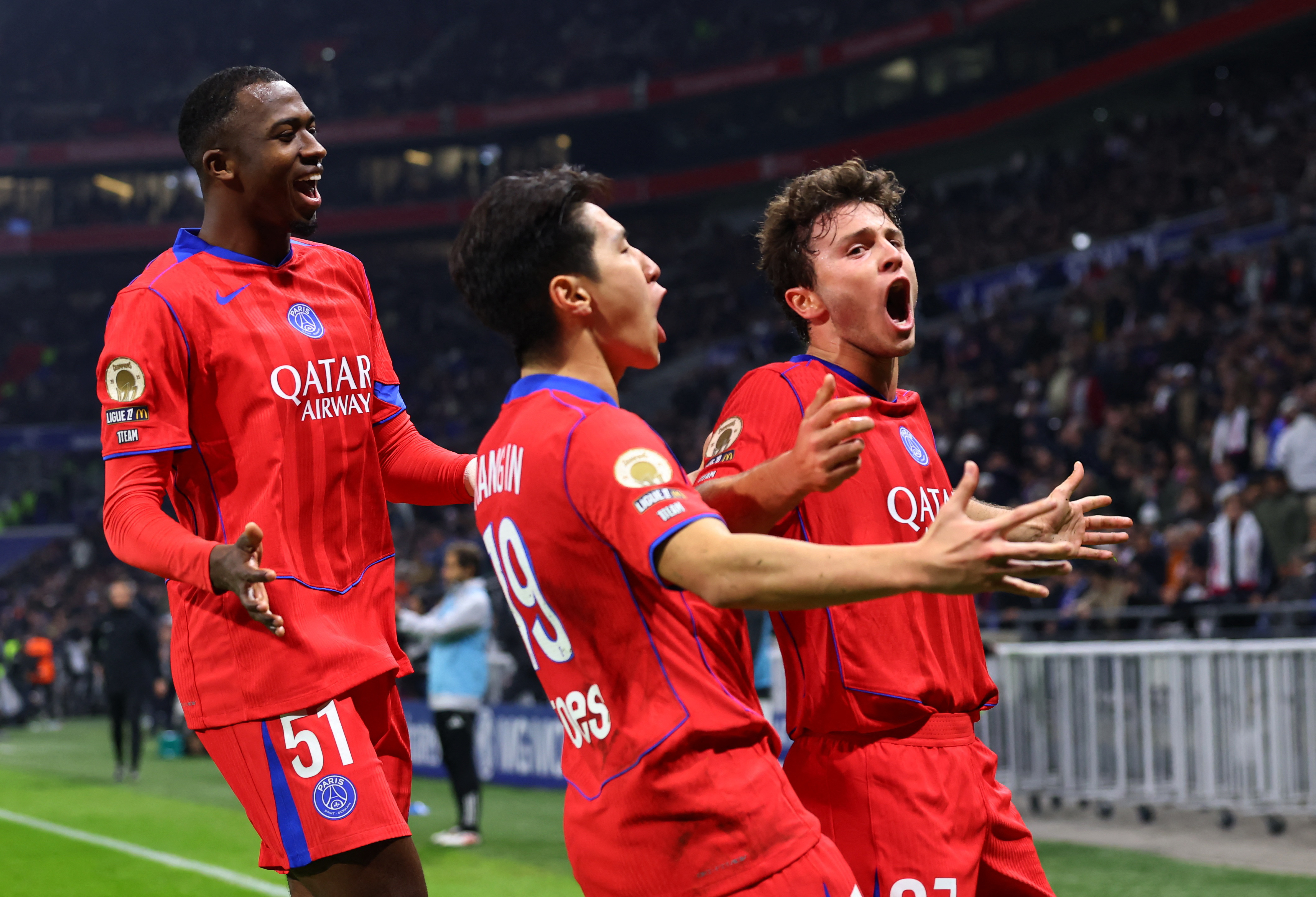 Soccer Football - Ligue 1 - Olympique Lyonnais v Paris St Germain - Groupama Stadium, Lyon, France - November 9, 2025 Paris St Germain's Joao Neves celebrates scoring their third goal with Lee Kang-in and Willian Pacho REUTERS/Manon Cruz