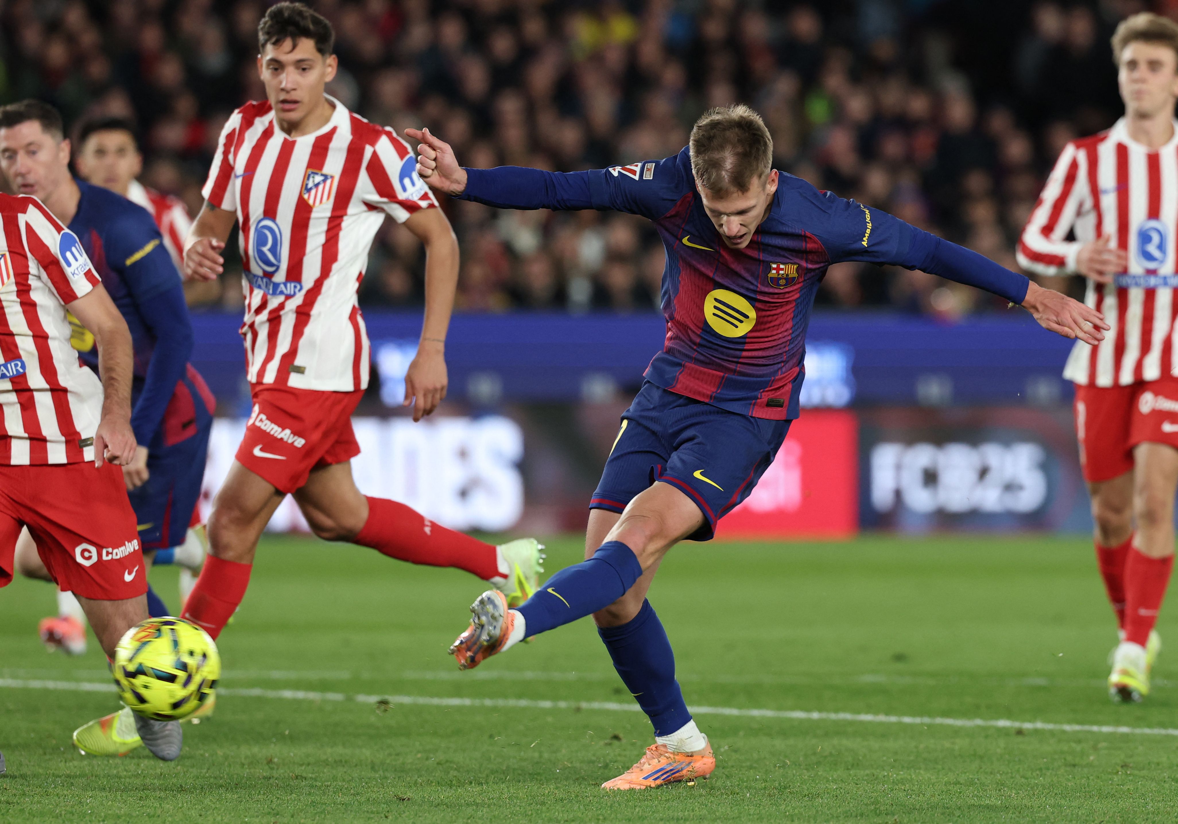 Barcelona's Spanish midfielder #20 Daniel Olmo scores his team's second goal during the Spanish league football match between FC Barcelona and Club Atletico de Madrid at Camp Nou Stadium in Barcelona on December 2, 2025. (Photo by Lluis GENE / AFP)