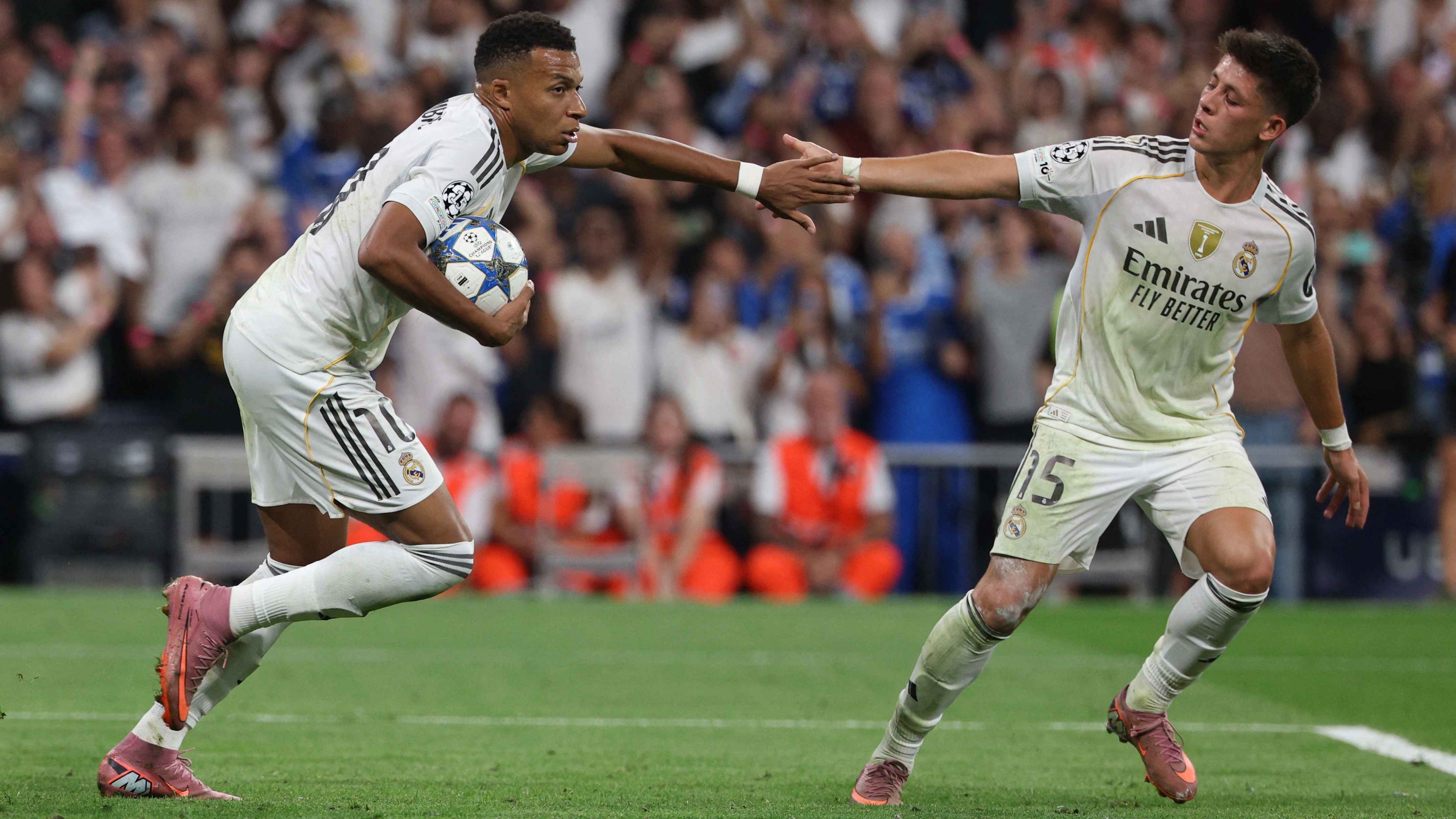 Soccer Football - UEFA Champions League - Real Madrid v Olympique de Marseille - Santiago Bernabeu, Madrid, Spain - September 16, 2025 Real Madrid's Kylian Mbappe celebrates scoring their first goal with Arda Guler REUTERS/Juan Medina