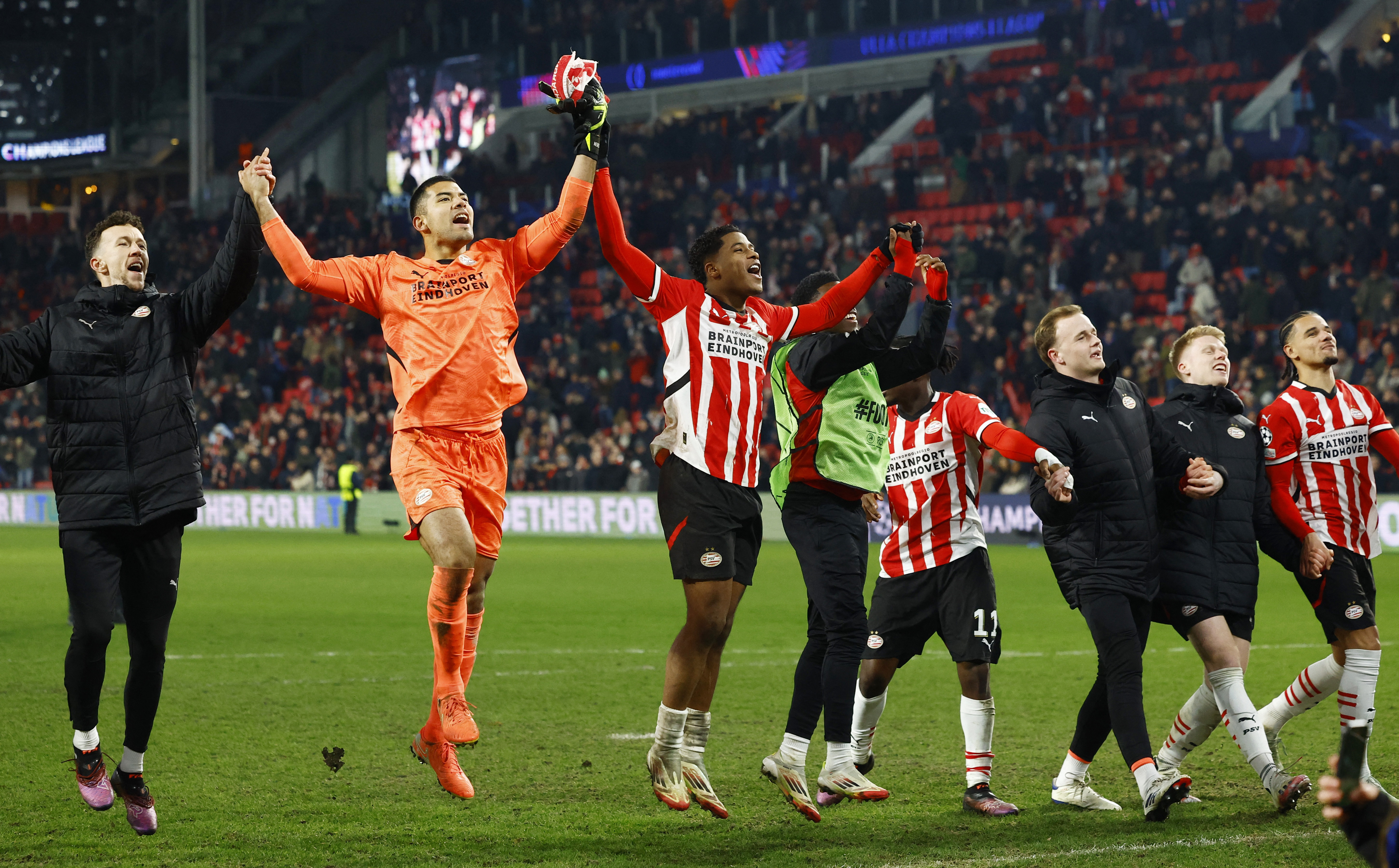 Soccer Football - Champions League - Knockout Phase Playoff - Second Leg - PSV Eindhoven v Juventus - Philips Stadion, Eindhoven, Netherlands - February 19, 2025 PSV Eindhoven's Walter Benitez celebrates after the match with teammates REUTERS/Piroschka Van De Wouw