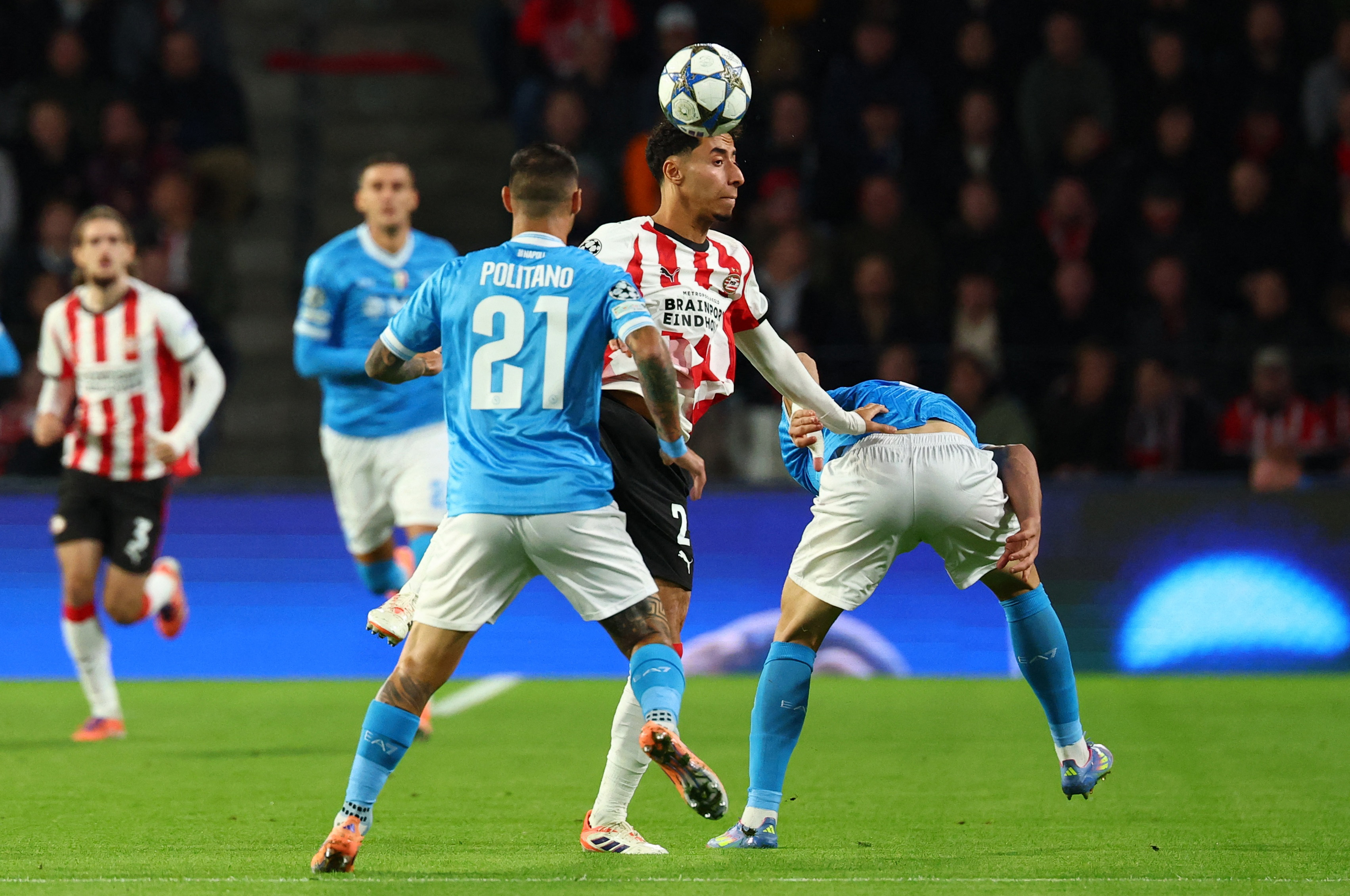 Soccer Football - UEFA Champions League - PSV Eindhoven v Napoli - Philips Stadion, Eindhoven, Netherlands - October 21, 2025 PSV Eindhoven's Anass Salah-Eddine in action with Napoli's Matteo Politano REUTERS/Piroschka Van De Wouw