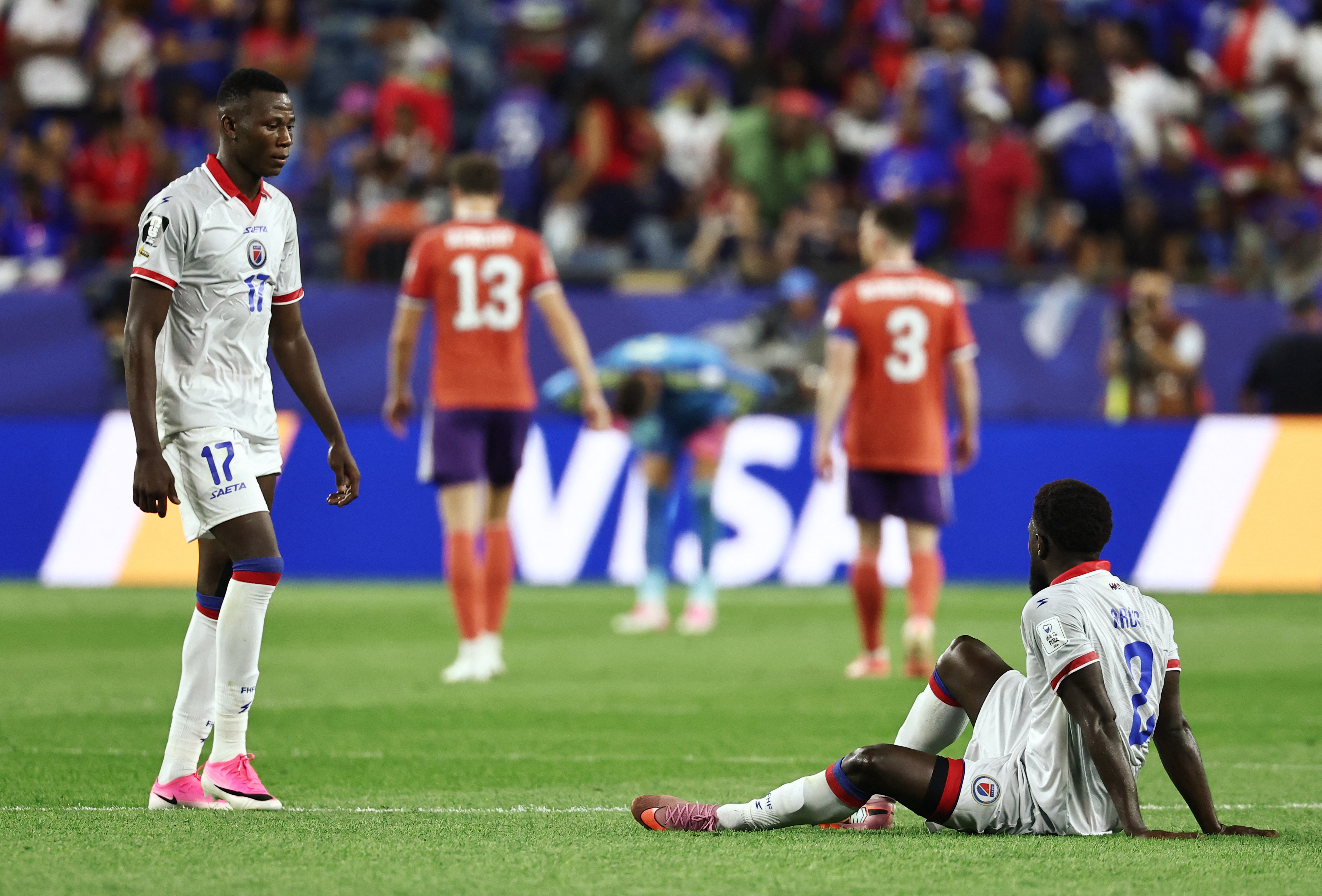 Haiti's Carlens Arcus and Danley Jean Jacques look dejected after the Scotland loss.