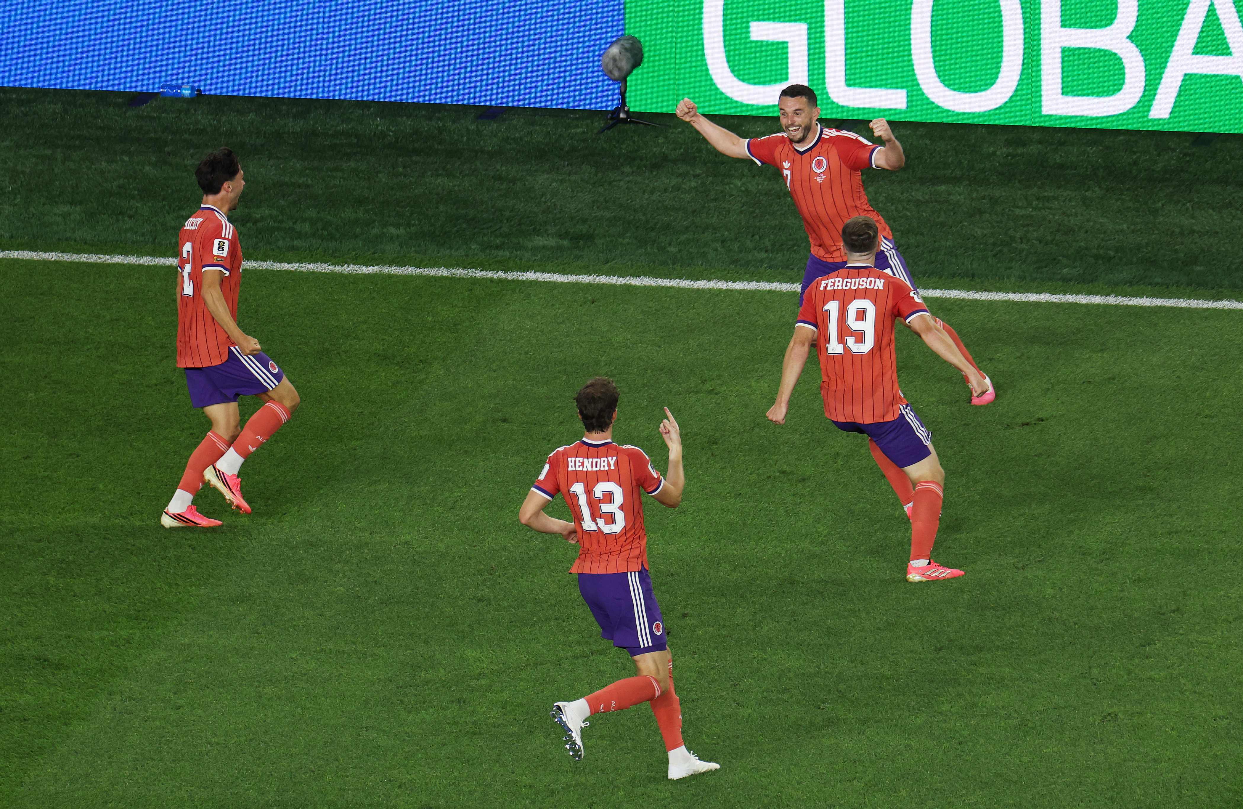 FOXBOROUGH, MASSACHUSETTS - JUNE 13: John McGinn (top) #7 of Scotland celebrates with teammates after scoring his team's first goal during the FIFA World Cup 2026 Group C match between Haiti and Scotland at Boston Stadium on June 13, 2026 in Foxborough, Massachusetts.   Mattia Ozbot/Getty Images/AFP (Photo by Mattia Ozbot / GETTY IMAGES NORTH AMERICA / Getty Images via AFP)