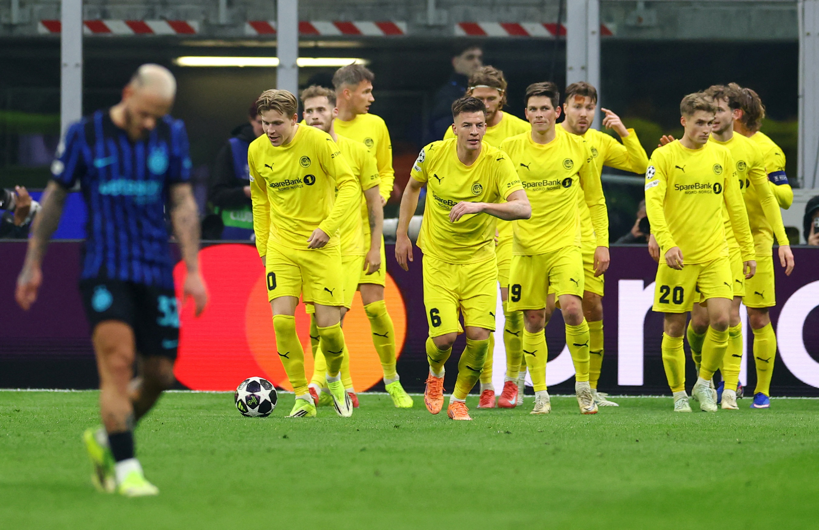 Soccer Football - UEFA Champions League - Play Off - Second Leg - Inter Milan v Bodo/Glimt - San Siro, Milan, Italy - February 24, 2026 Bodo/Glimt's Hakon Evjen celebrates scoring their second goal with teammates REUTERS/Claudia Greco