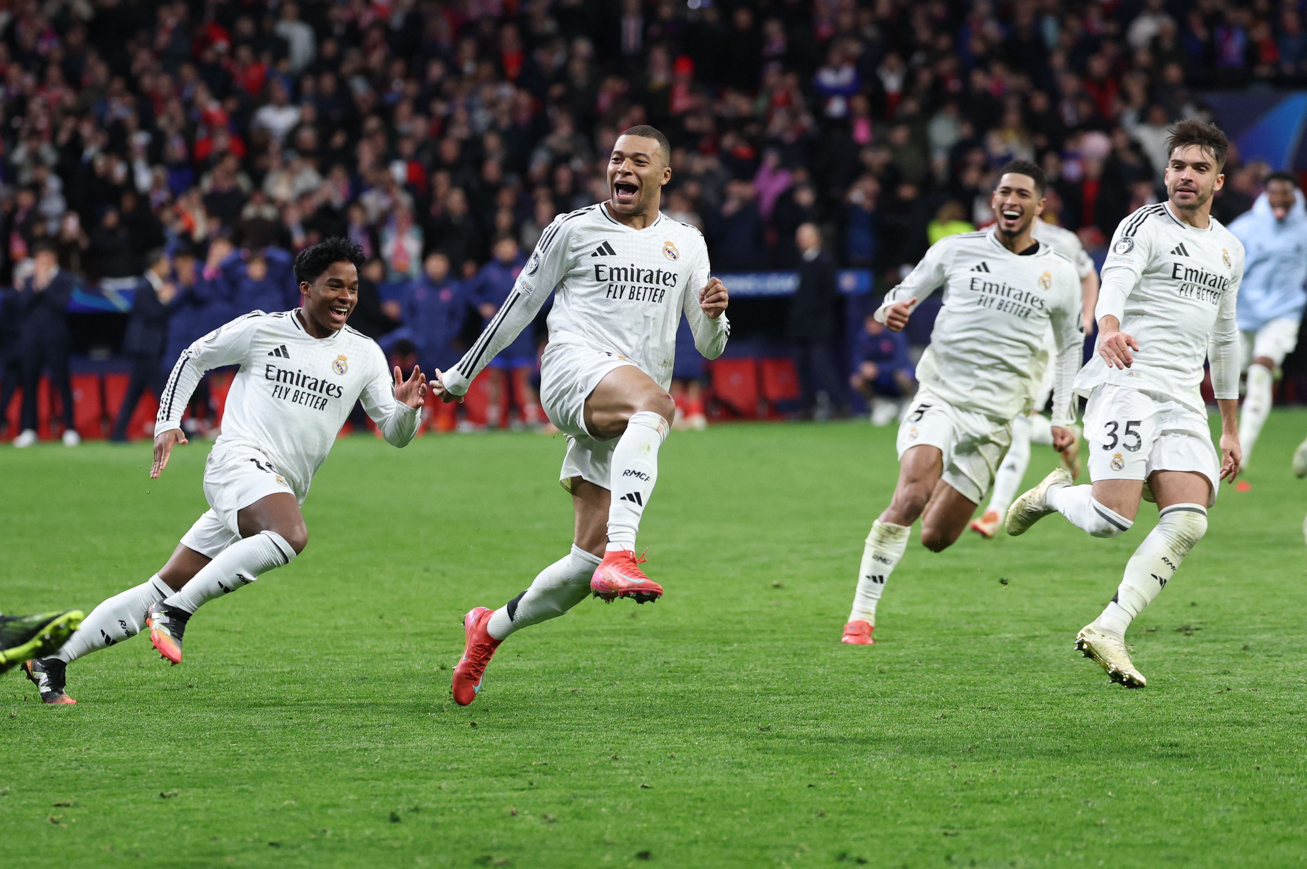 (From L) Real Madrid's Brazilian forward #16 Endrick, Real Madrid's French forward #09 Kylian Mbappe, Real Madrid's English midfielder #05 Jude Bellingham and Real Madrid's Spanish defender #35 Raul Asencio celebrate their victory after the penalty shoot out after the UEFA Champions League Round of 16 second leg football match between Club Atletico de Madrid and Real Madrid CF at the Metropolitano stadium in Madrid on March 12, 2025. (Photo by Thomas COEX / AFP)