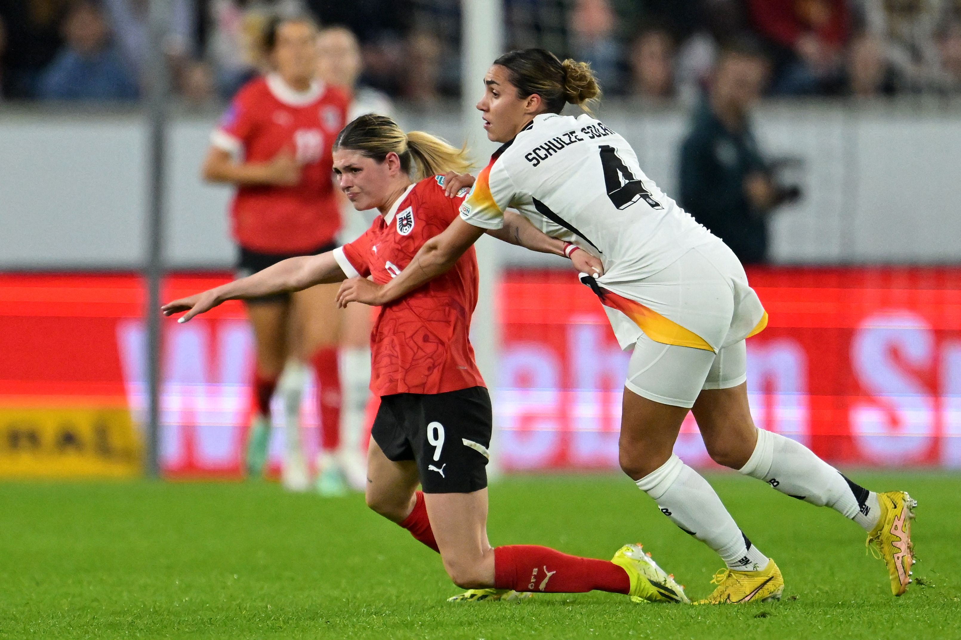 Austria's forward #09 Eileen Campbell (L) is fouled by Germany's defender #04 Bibiane Schulze Solano during the UEFA Women's Euro 2025 qualifying football match between Austria and Germany in Linz, Austria on April 5, 2024. (Photo by Joe Klamar / AFP)