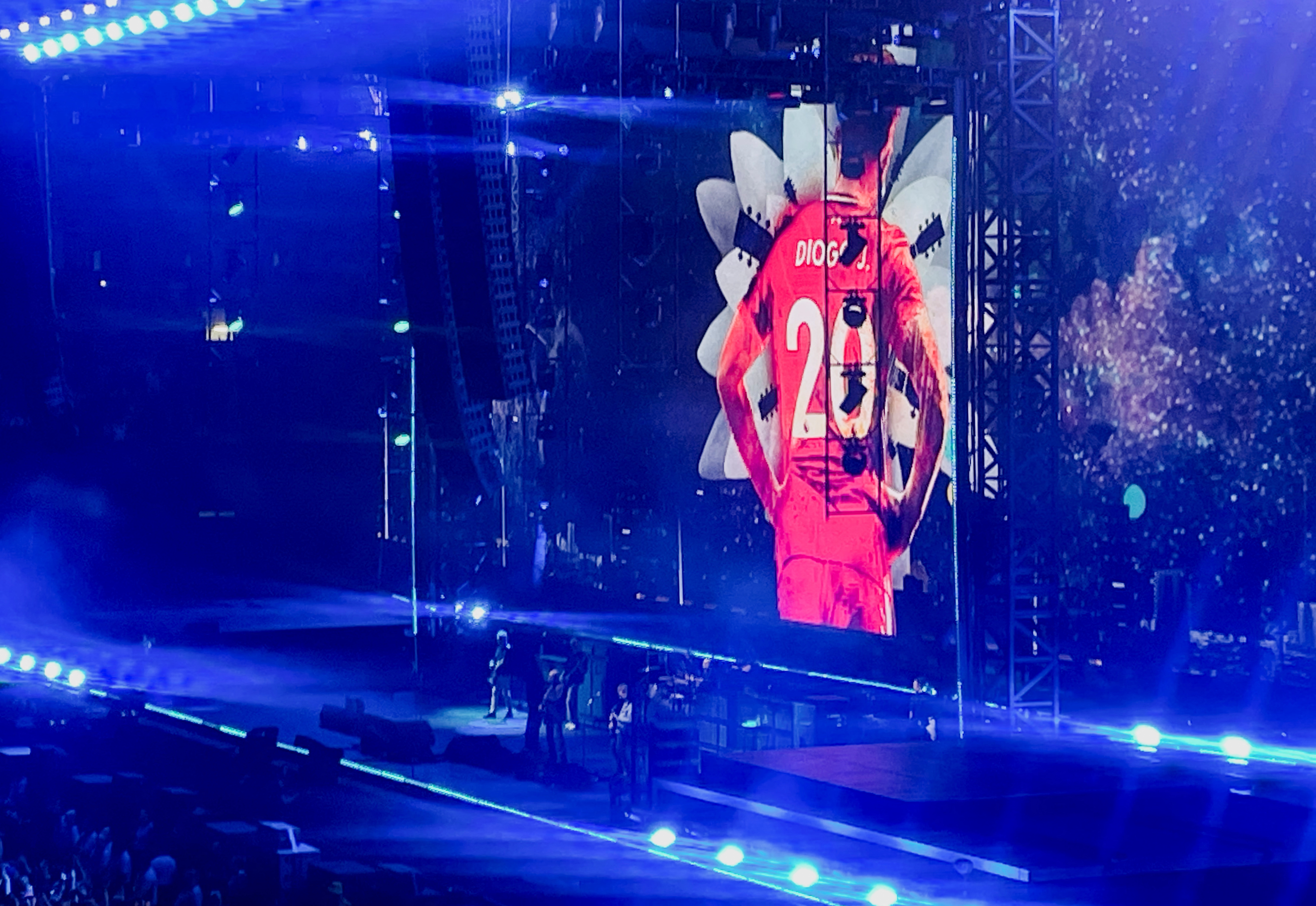 A picture of Liverpool and Portugal footballer Diogo Jota, who was killed in a car accident on Thursday, is projected on a screen behind the British rock band Oasis, during the first of their sellout comeback shows, at the Cardiff Principality Stadium, in Cardiff, Wales, Britain, July 4, 2025. REUTERS/Paul Sandle NO RESALES. NO ARCHIVES. NO USE AFTER 365 DAYS AFTER PUBLICATION. PHOTOGRAPHS MAY BE PUBLISHED IN CONTEXT WITH THE SHOW ONLY.