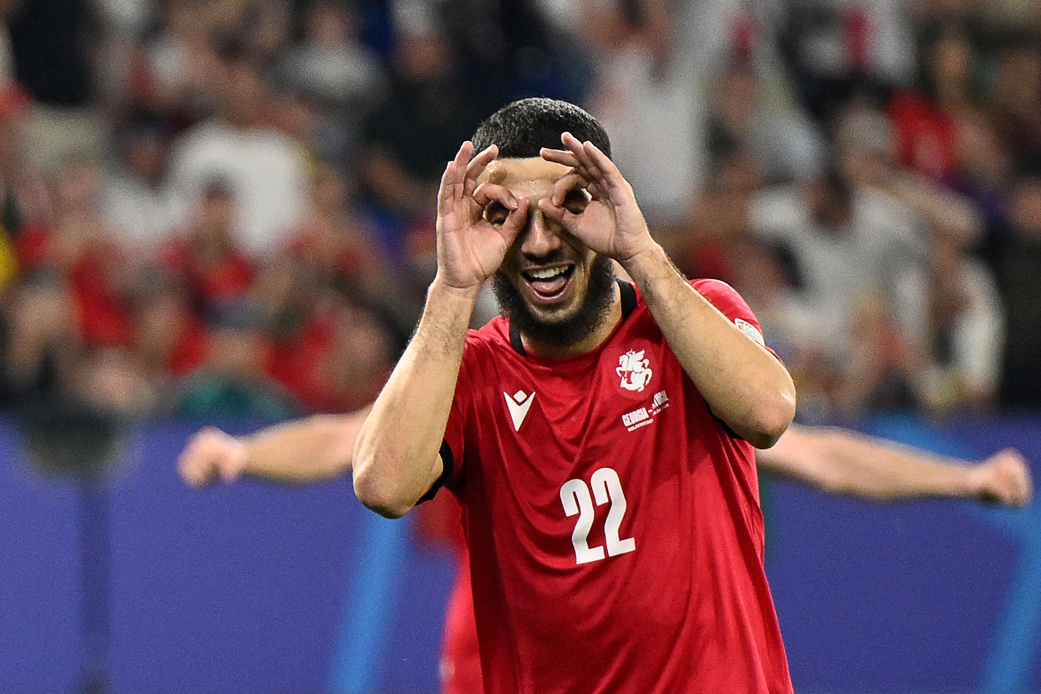 Georgia's forward #22 Georges Mikautadze celebrates scoring his team's second goal during the UEFA Euro 2024 Group F football match between Georgia and Portugal at the Arena AufSchalke in Gelsenkirchen on June 26, 2024. (Photo by INA FASSBENDER / AFP)
