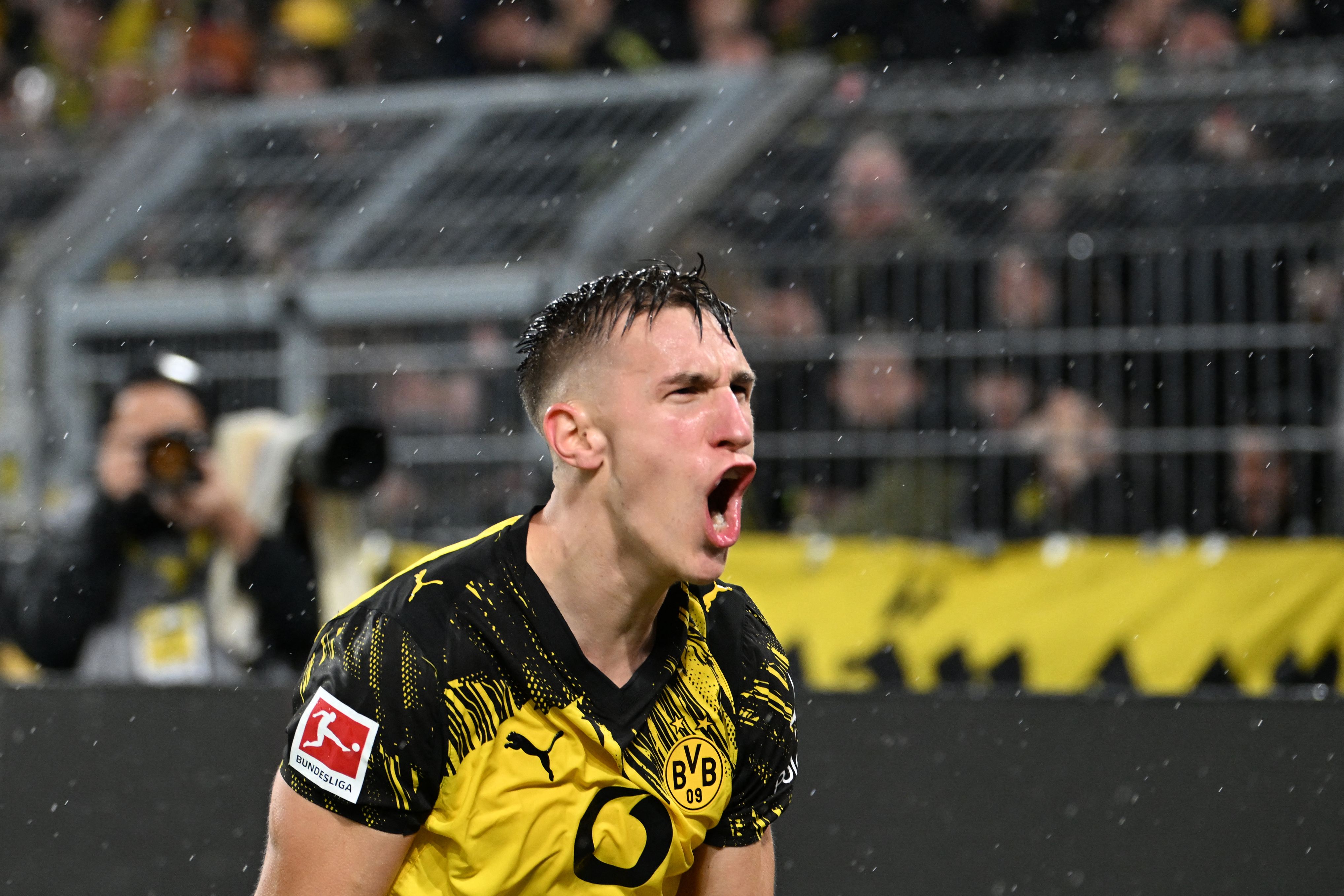 Dortmund's German defender #04 Nico Schlotterbeck celebrates after scoring the 2-0 goal during the German first division Bundesliga football match between BVB Borussia Dortmund and TSG 1899 Hoffenheim in Dortmund, western Germany, on December 7, 2025. (Photo by UWE KRAFT / AFP) / DFL REGULATIONS PROHIBIT ANY USE OF PHOTOGRAPHS AS IMAGE SEQUENCES AND/OR QUASI-VIDEO