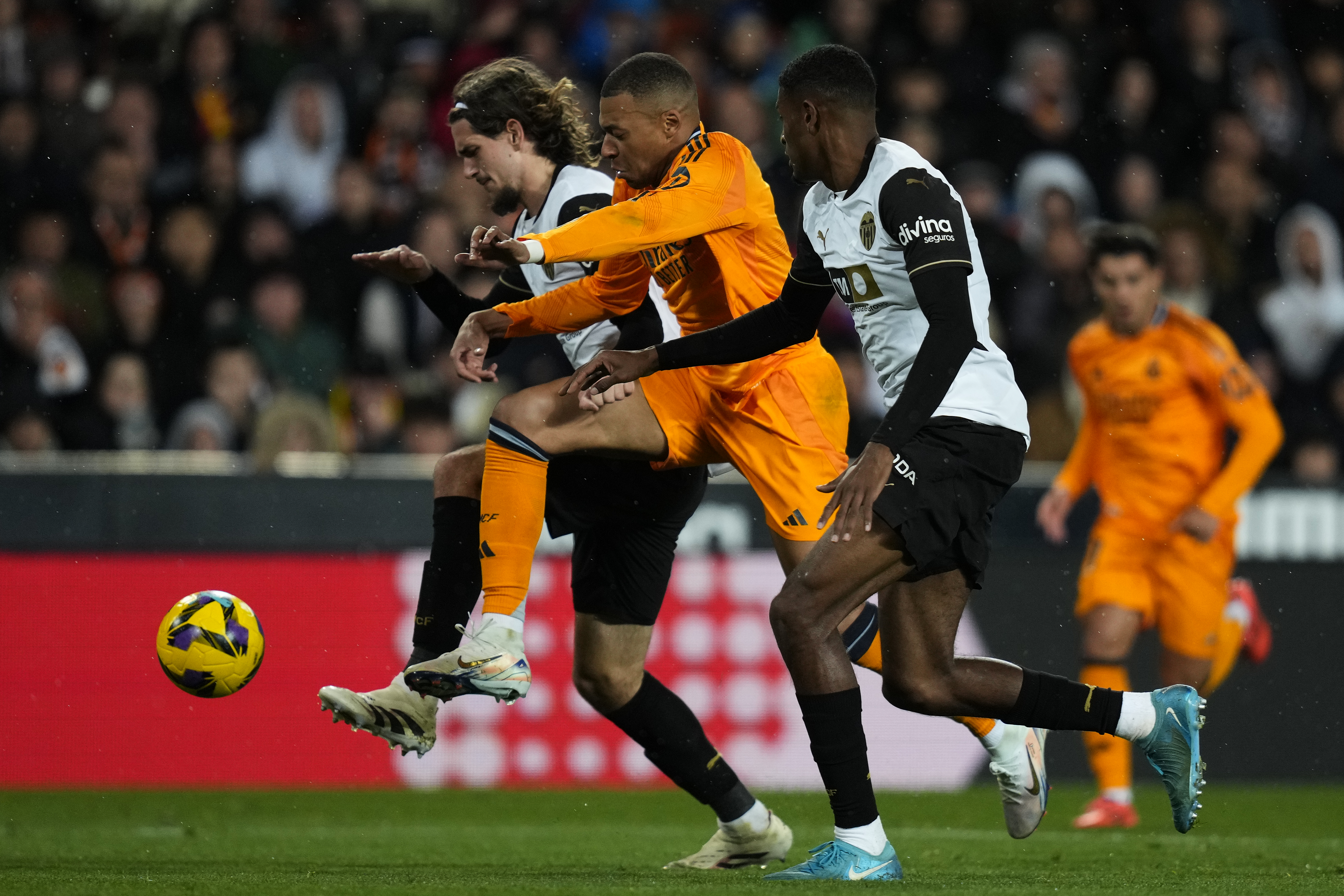 VALENCIA, SPAIN - JANUARY 03: Yarek Gasiorowski of Valencia CF battle for the ball with Kylian Mbappe of Real Madrid CF during the LaLiga match between Valencia CF and Real Madrid CF at Estadio Mestalla on January 03, 2025 in Valencia, Spain. (Photo by Diego Souto/Getty Images)