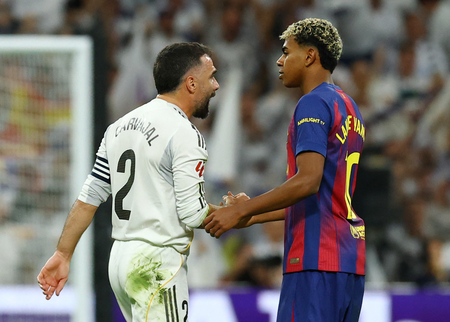 The Spanish right-back shakes hands with FC Barcelona's Lamine Yamal after the game.