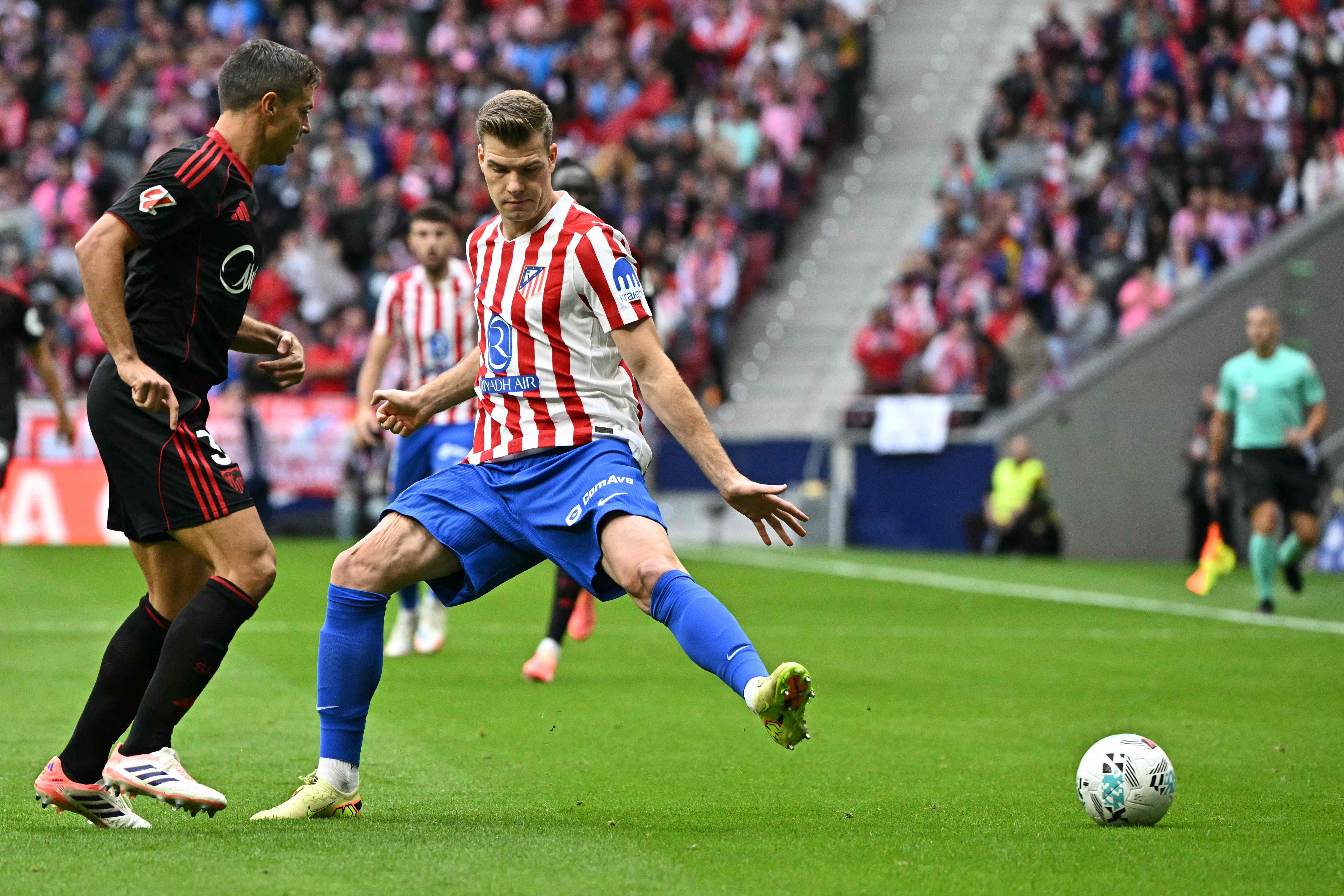 Sevilla's Spanish defender #03 Cesar Azpilicueta (L) and Atletico Madrid's Norwegian forward #09 Alexander Sorloth vie for the ball during the Spanish League football match between Club Atletico de Madrid and Sevilla FC at Metropolitano Stadium in Madrid on November 1, 2025. (Photo by JAVIER SORIANO / AFP)