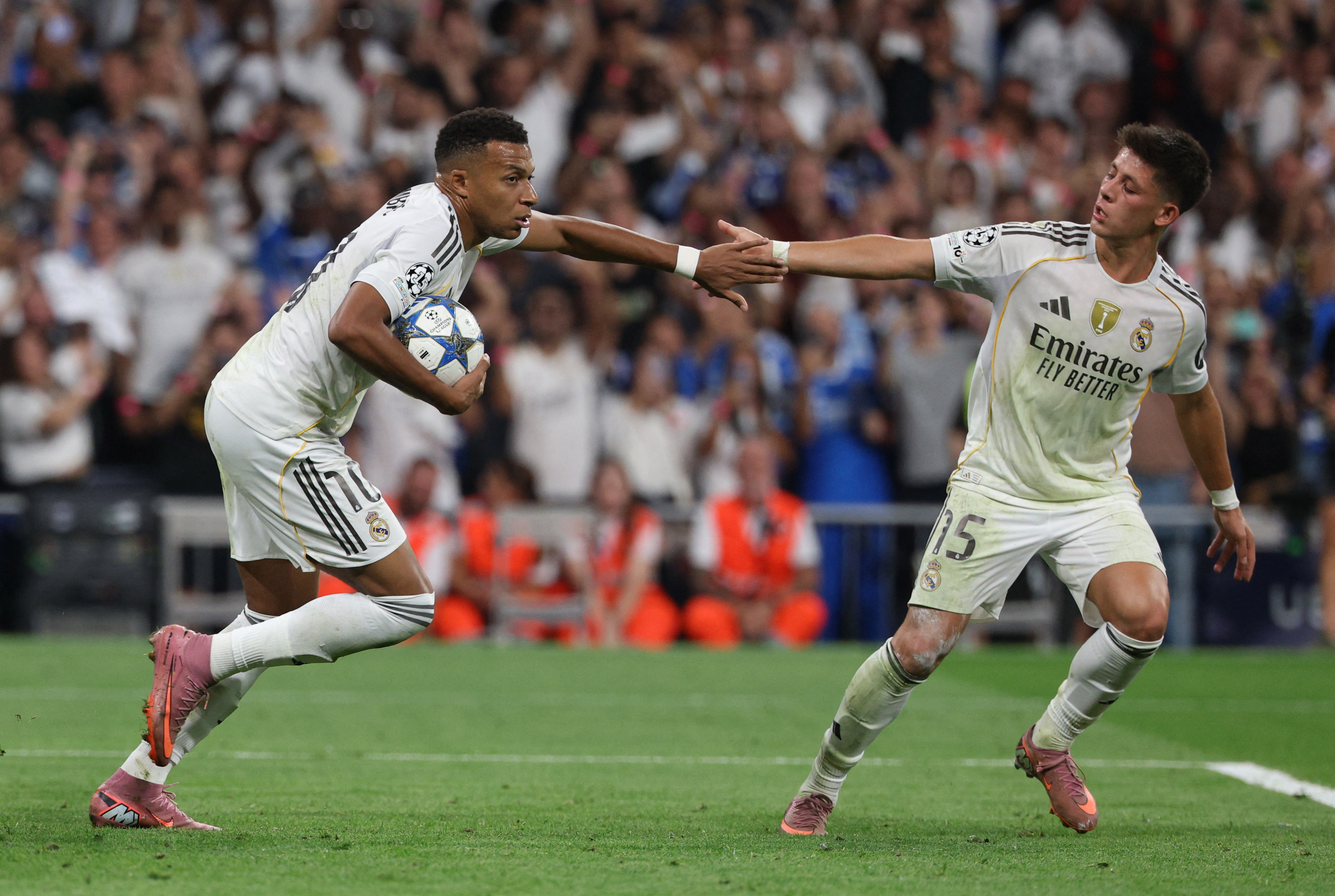 Soccer Football - UEFA Champions League - Real Madrid v Olympique de Marseille - Santiago Bernabeu, Madrid, Spain - September 16, 2025 Real Madrid's Kylian Mbappe celebrates scoring their first goal with Arda Guler REUTERS/Juan Medina