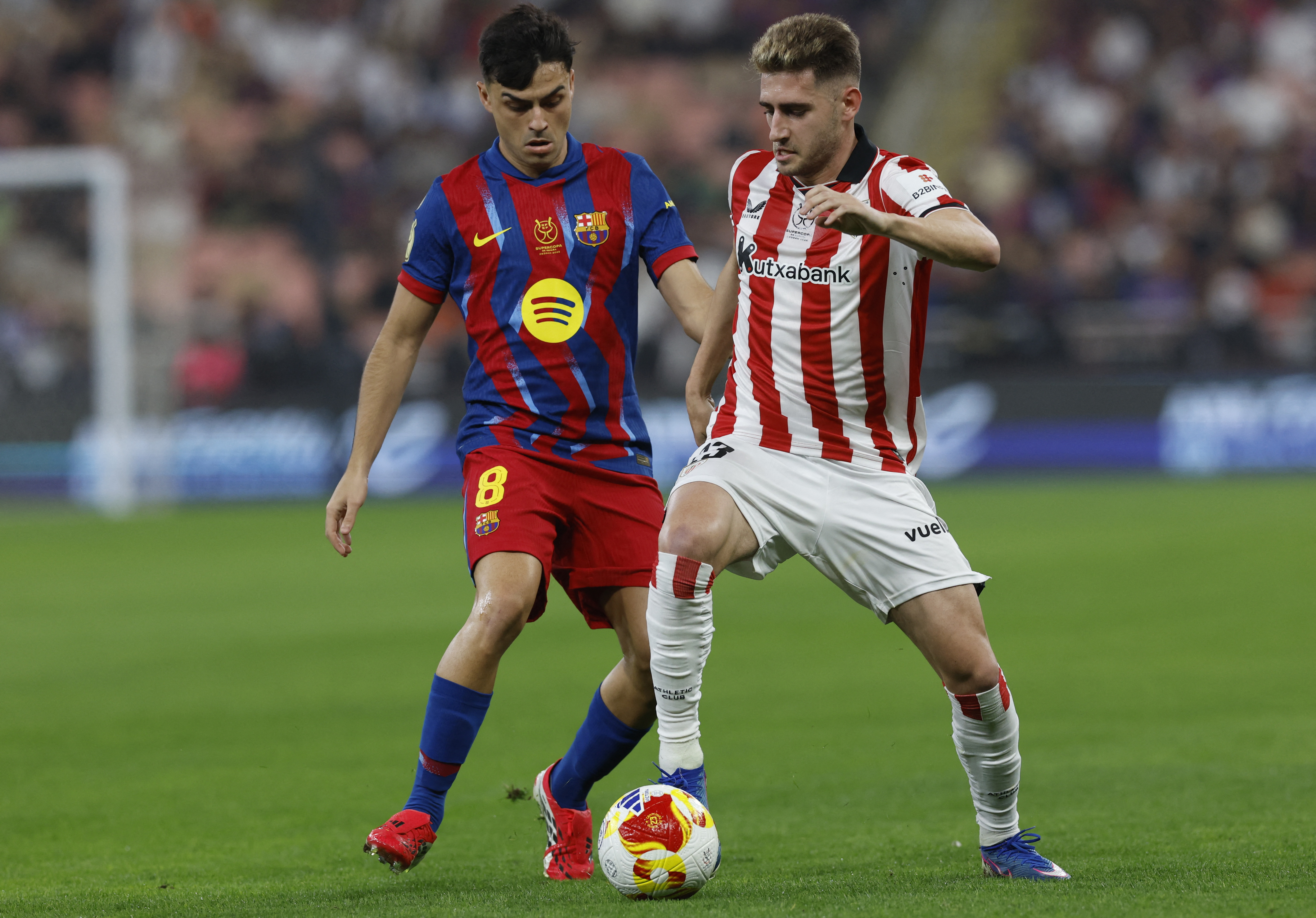 Soccer Football - Spanish Super Cup - Semi Final - FC Barcelona v Athletic Bilbao - King Abdullah Sports City, Jeddah, Saudi Arabia - January 7, 2026 FC Barcelona's Pedri in action with Athletic Bilbao's Robert Navarro REUTERS/Vincent West