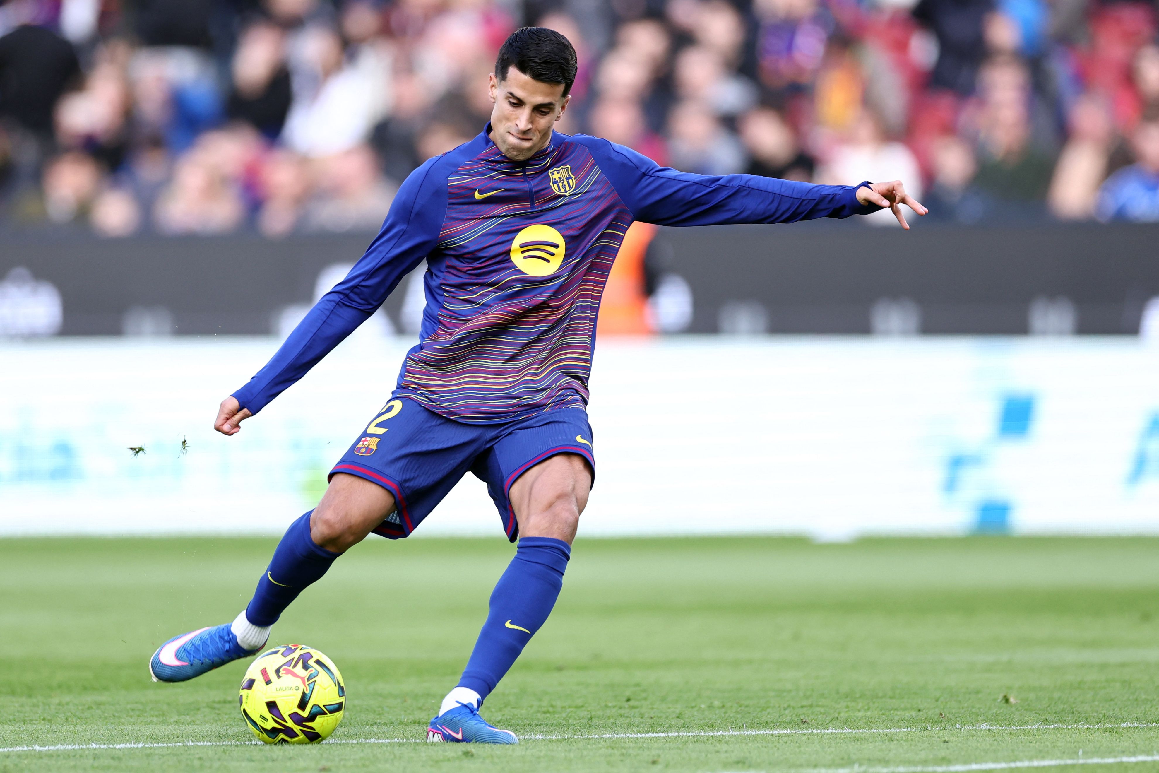 Barcelona's Portuguese defender #02 Joao Cancelo warms up before the Spanish league football match between FC Barcelona and Real Oviedo at Camp Nou Stadium in Barcelona on January 25, 2026. (Photo by Josep LAGO / AFP)