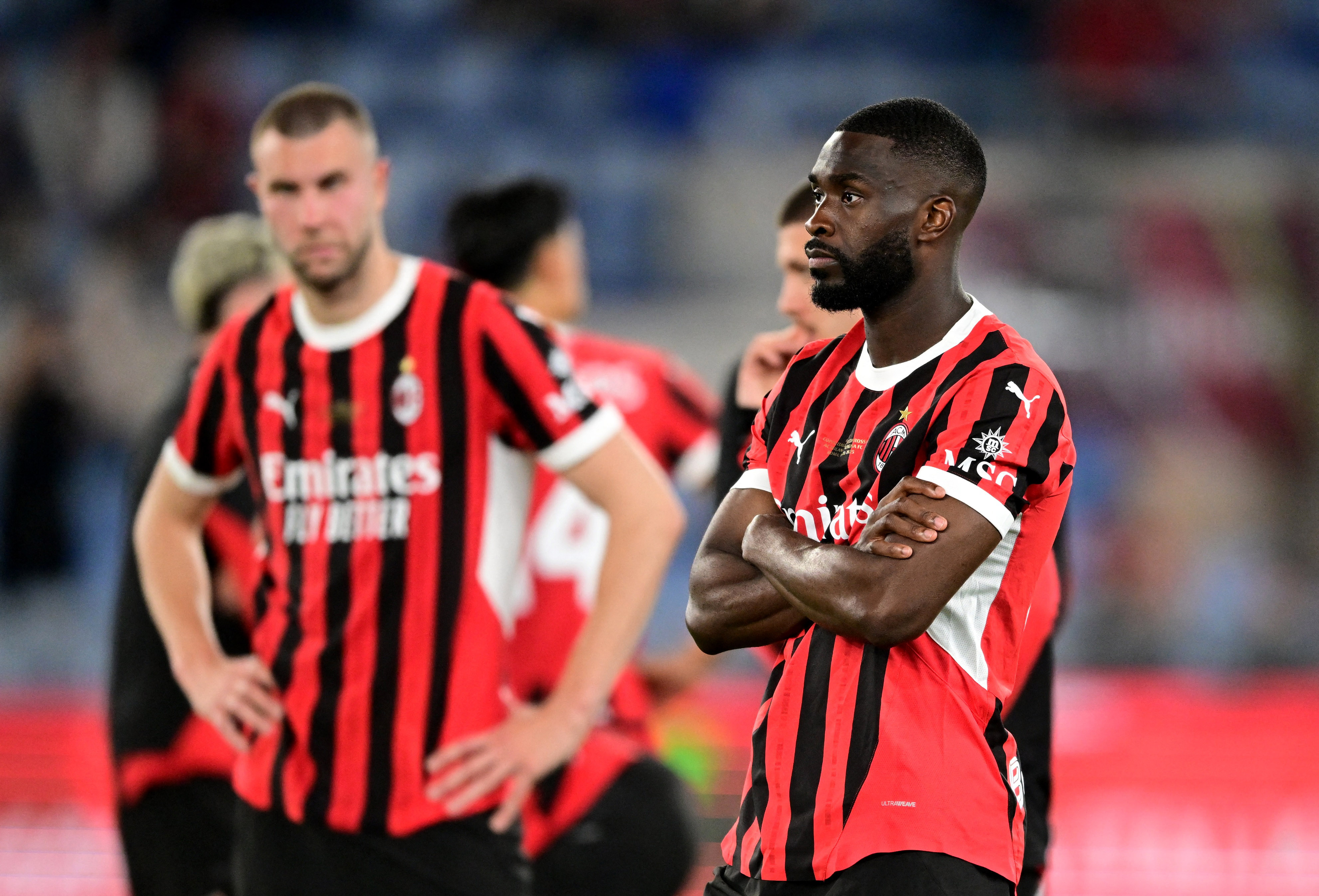 Soccer Football - Coppa Italia - Final - AC Milan v Bologna - Stadio Olimpico, Rome, Italy - May 14, 2025 AC Milan's Fikayo Tomori and Strahinja Pavlovic look dejected after the match REUTERS/Daniele Mascolo