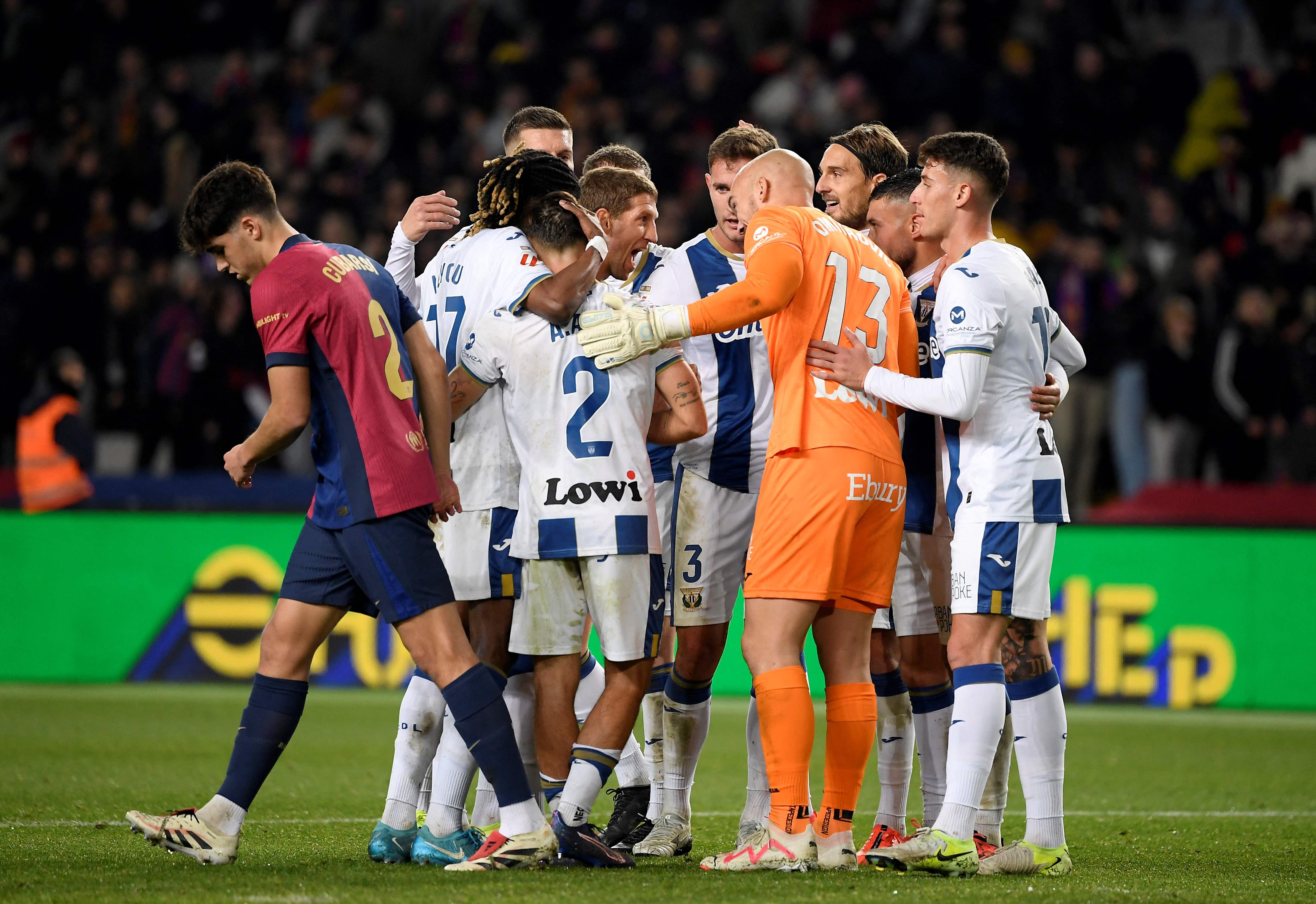 Leganes players celebrate victory at the end of the Spanish league football match between FC Barcelona and Club Deportivo Leganes SAD at the Estadi Olimpic Lluis Companys in Barcelona on December 15, 2024. Leganes won 0-1. (Photo by Josep LAGO / AFP)