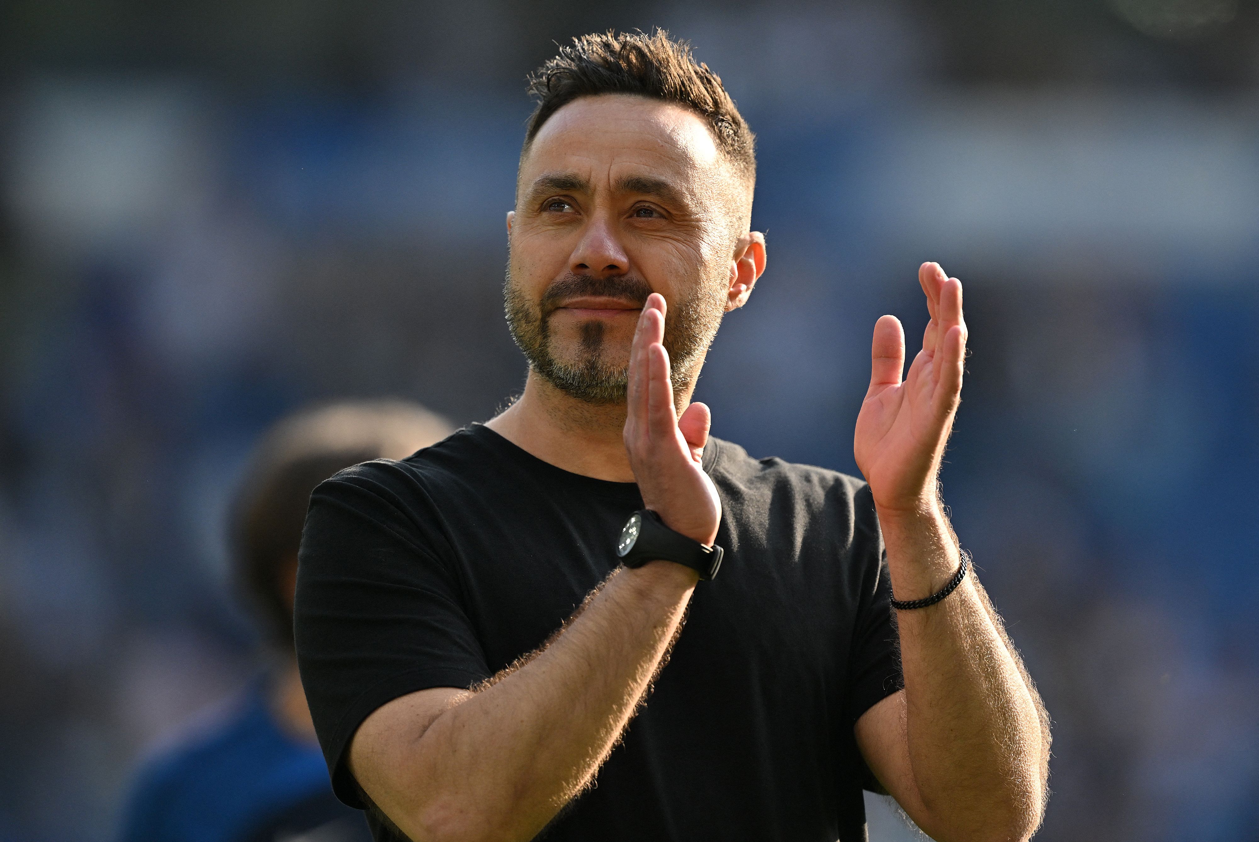 Brighton's Italian head coach Roberto De Zerbi applauds the fans following the English Premier League football match between Brighton and Hove Albion and Manchester United at the American Express Community Stadium in Brighton, southern England on May 19, 2024. Brighton boss Roberto De Zerbi will leave the Premier League club by mutual consent after their final game of the season against Manchester United on Sunday. De Zerbi took charge at the Amex Stadium in September 2022 and led Brighton to their highest ever top-flight finish when they came sixth in 2022-23. (Photo by Glyn KIRK / AFP) / RESTRICTED TO EDITORIAL USE. No use with unauthorized audio, video, data, fixture lists, club/league logos or 'live' services. Online in-match use limited to 120 images. An additional 40 images may be used in extra time. No video emulation. Social media in-match use limited to 120 images. An additional 40 images may be used in extra time. No use in betting publications, games or single club/league/player publications. / 