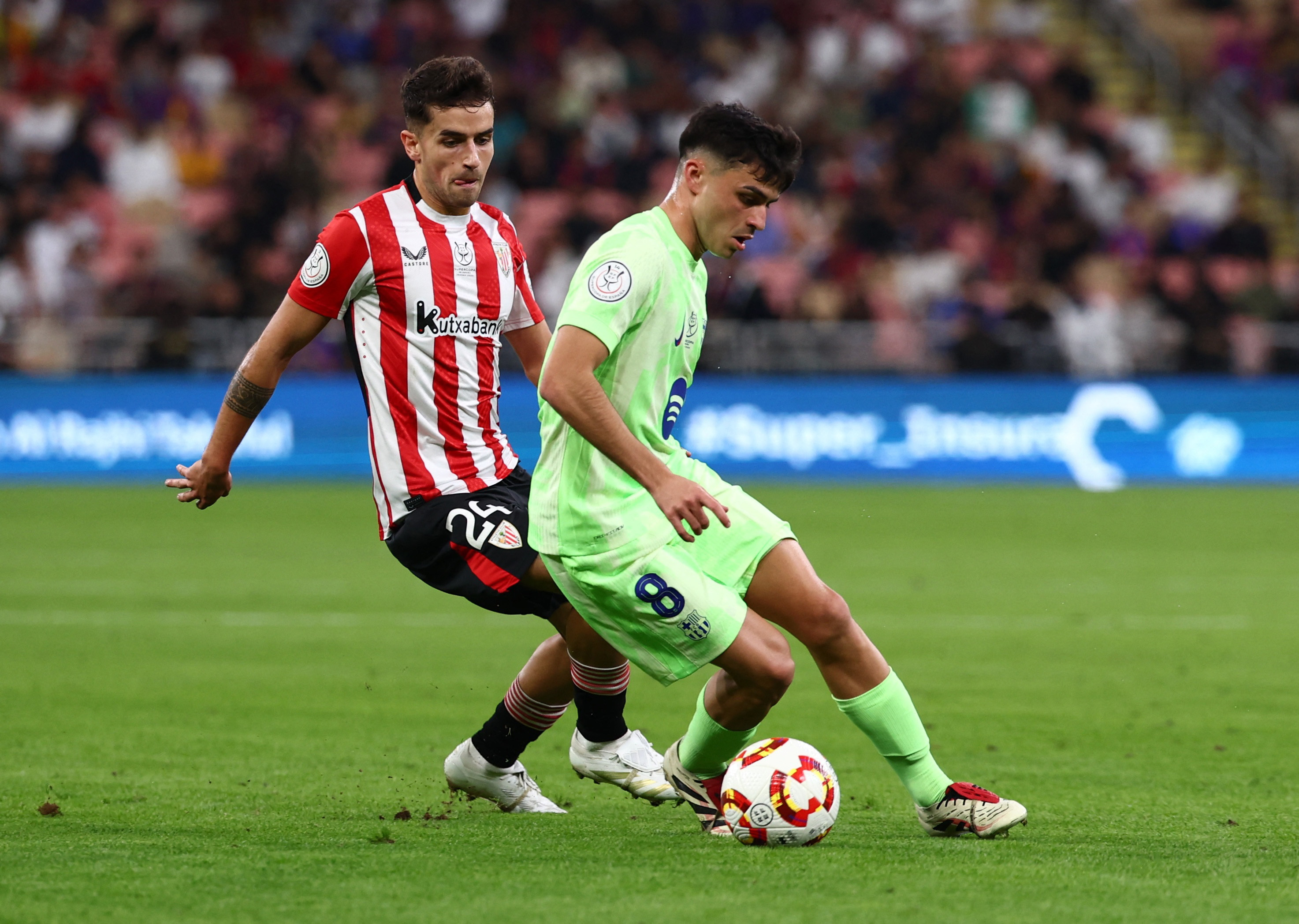 Soccer Football - Spanish Super Cup - Semi Final - Athletic Bilbao v FC Barcelona - King Abdullah Sports City, Jeddah, Saudi Arabia - January 8, 2025 FC Barcelona's Pedri in action with Athletic Bilbao's Benat Prados REUTERS/Pedro Nunes