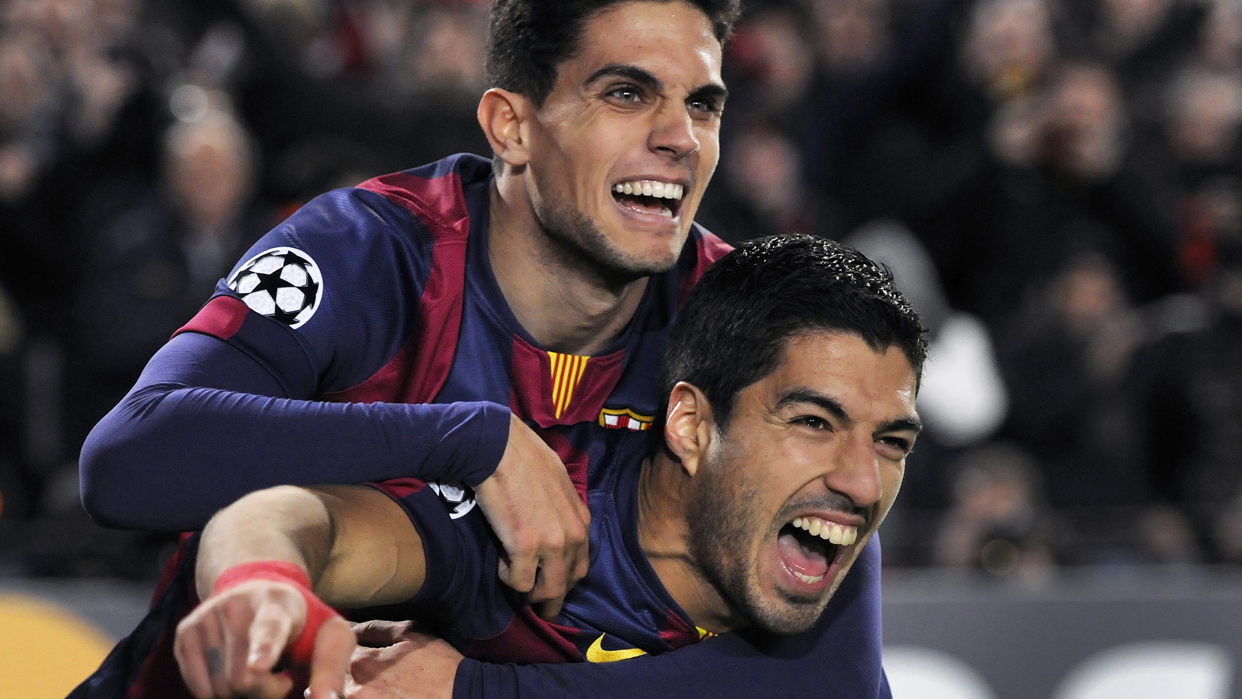 Luis Suarez of FC Barcelona is congratulated by team mate Marc Bartra after scoring during the Champions League Group F match between FC Barcelona and Paris St Germain at the Nou Camp in Barcelona, UK. Photo: Visionhaus/Gary Prior (Photo by Ben Radford/Corbis via Getty Images)