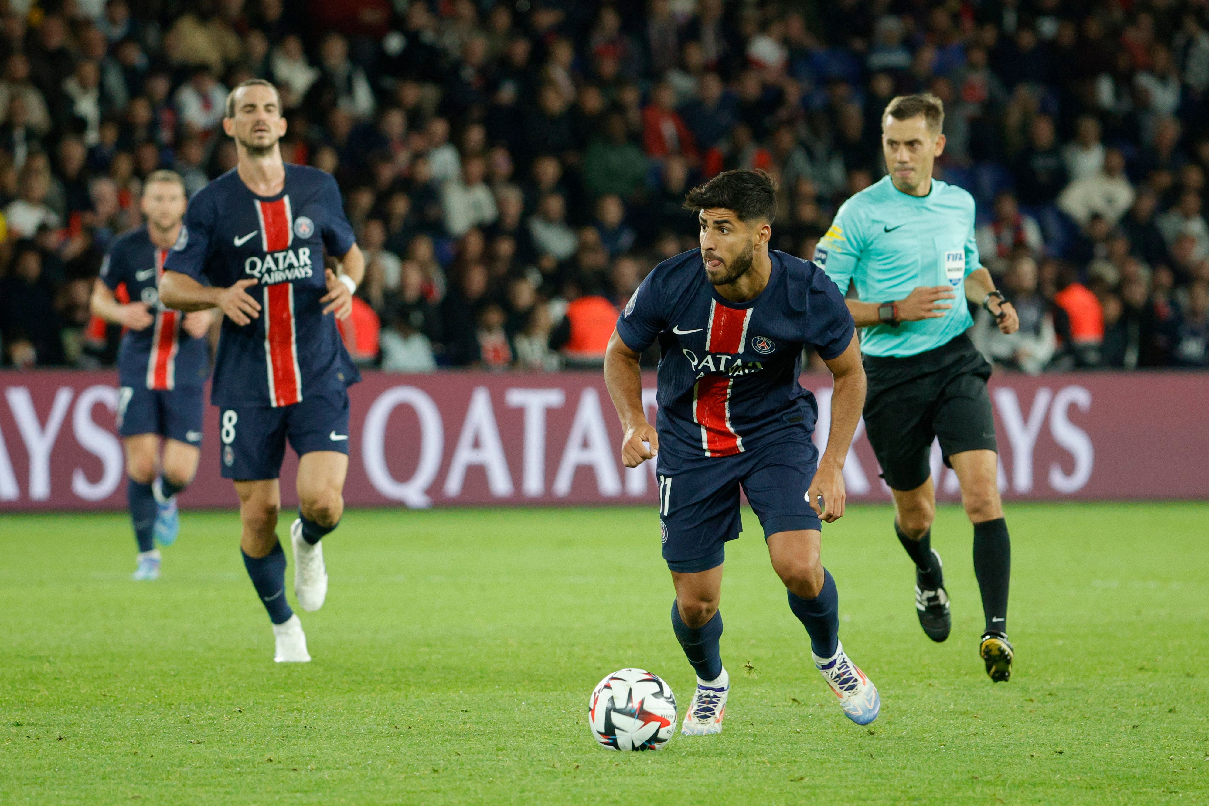 Paris Saint-Germain's Spanish forward #11 Marco Asensio (C) runs with the ball during the French L1 football match between Paris Saint-Germain (PSG) and Stade Brestois 29 (Brest) at The Parc des Princes Stadium, in Paris, on September 14, 2024. (Photo by GEOFFROY VAN DER HASSELT / AFP)