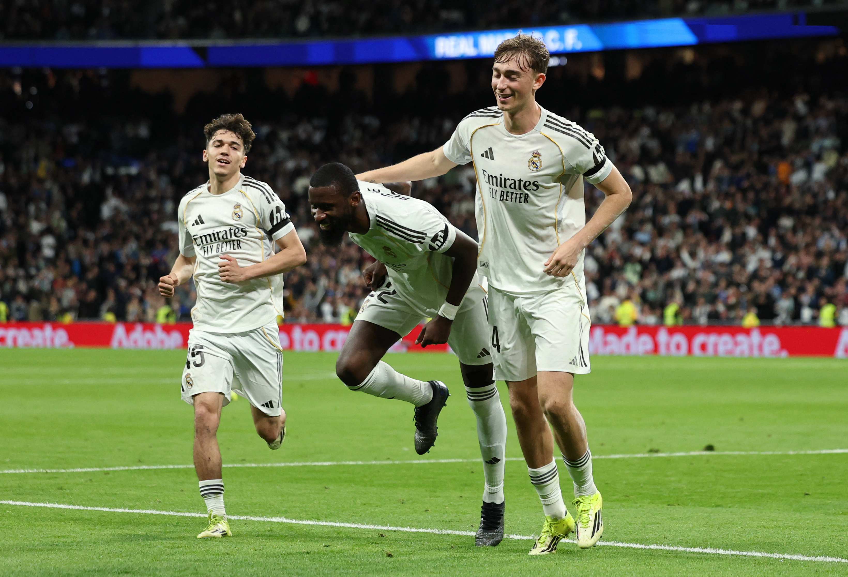 Soccer Football - LaLiga - Real Madrid v Elche - Santiago Bernabeu, Madrid, Spain - March 14, 2026 Real Madrid's Antonio Rudiger celebrates scoring their first goal with Dean Huijsen and Thiago Pitarch REUTERS/Violeta Santos Moura