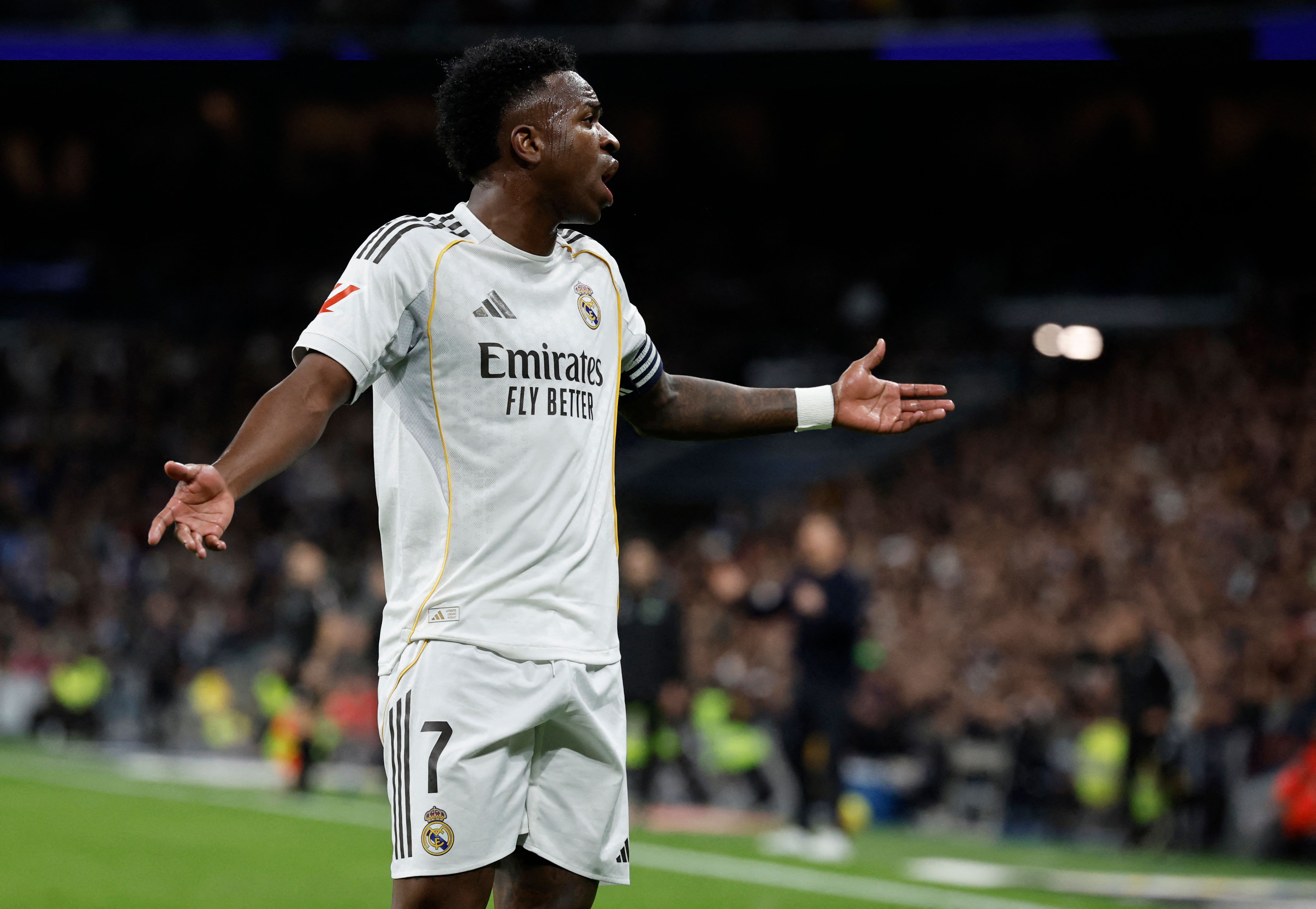 Real Madrid's Brazilian forward #07 Vinicius Junior reacts during the Spanish league football match between Real Madrid CF and Sevilla FC at Santiago Bernabeu Stadium in Madrid on December 20, 2025. (Photo by Oscar DEL POZO / AFP)