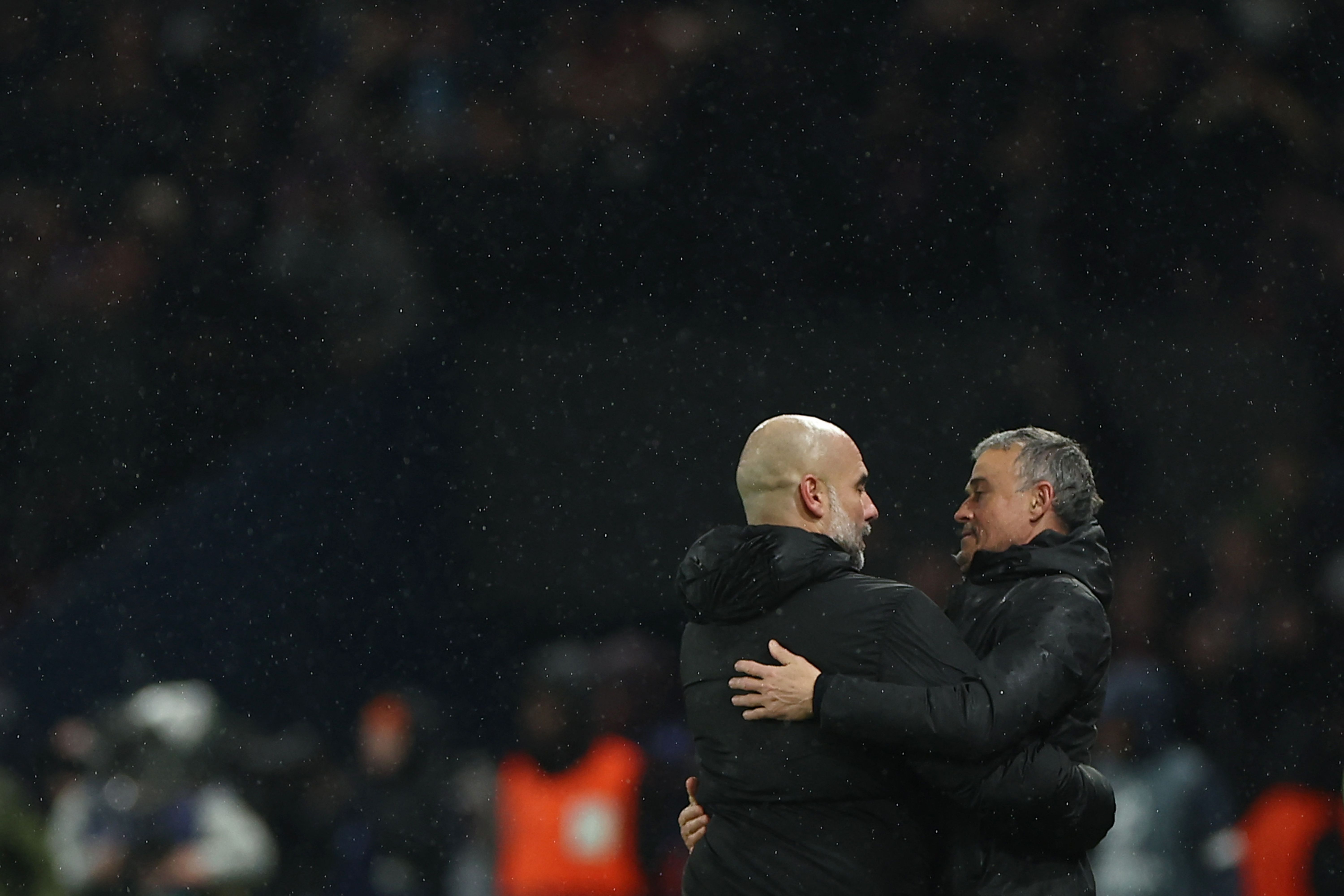 Paris Saint-Germain's Spanish headcoach Luis Enrique (R) embraces Manchester City's Spanish manager Pep Guardiola at the end of the UEFA Champions League, league phase football match between Paris Saint-Germain and Manchester City at the Parc des Princes Stadium in Paris on January 22, 2025. (Photo by FRANCK FIFE / AFP)