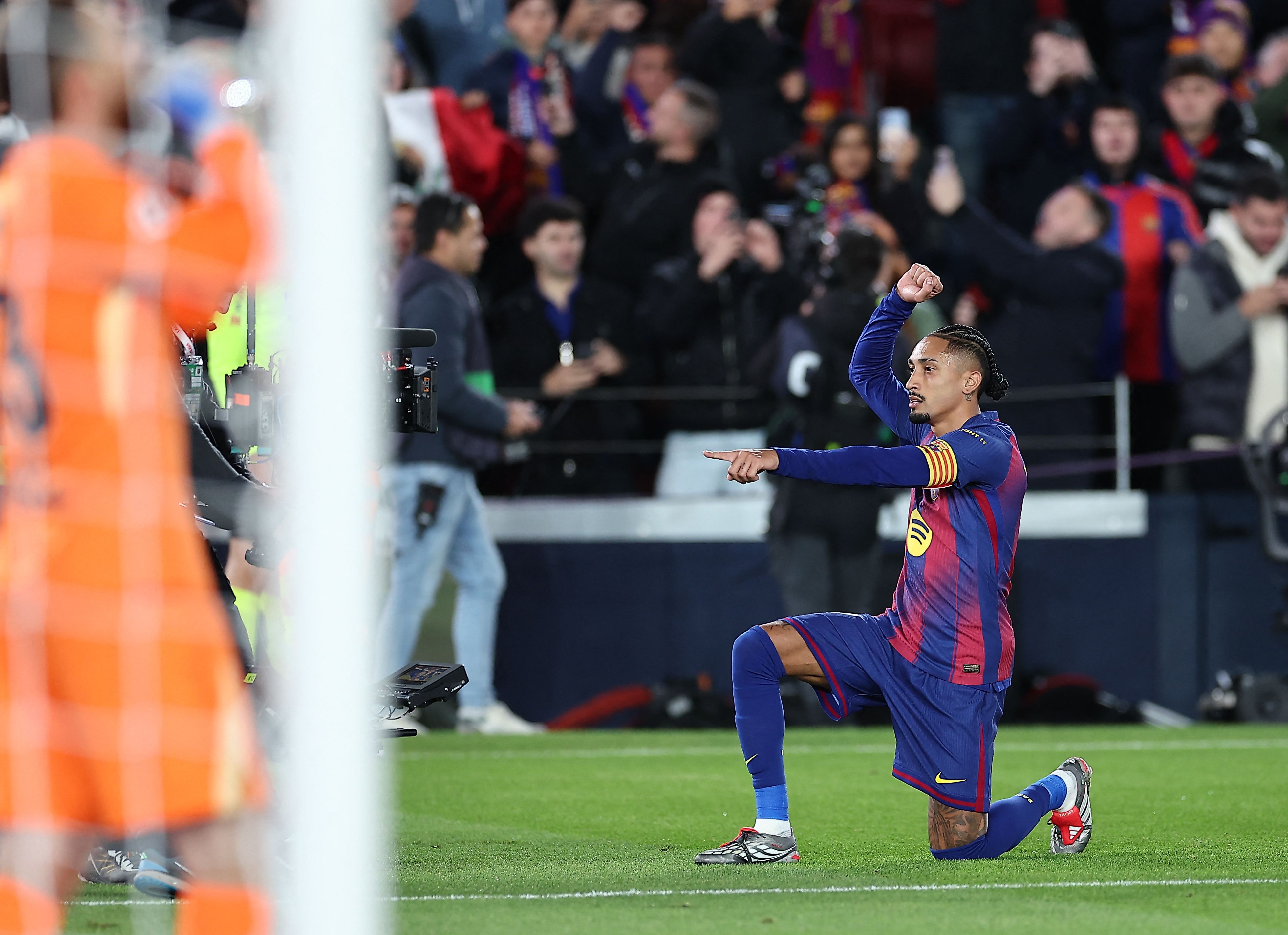 Barcelona's Brazilian forward #11 Raphinha celebrates scoring his team's first goal during the Spanish league football match between FC Barcelona and Club Atletico de Madrid at Camp Nou Stadium in Barcelona on December 2, 2025. (Photo by Josep LAGO / AFP)