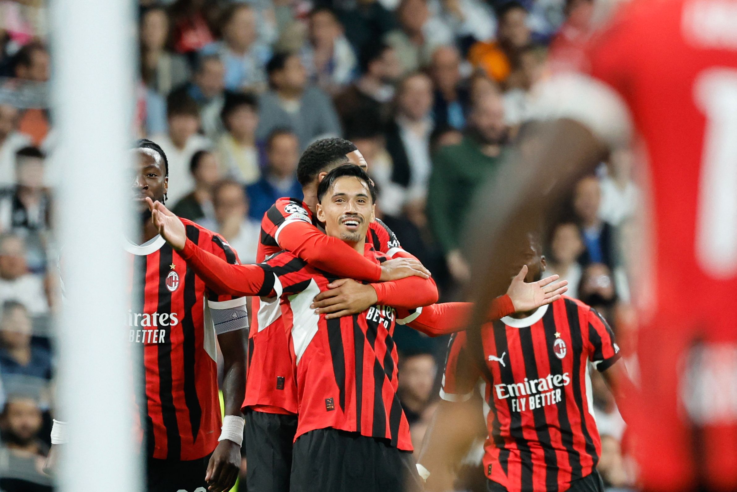 AC Milan's Dutch midfielder #14 Tijani Reijnders (C) celebrates scoring their third goal during the UEFA Champions League, league phase day 4 football match between Real Madrid CF and AC Milan at the Santiago Bernabeu stadium in Madrid on November 5, 2024. (Photo by OSCAR DEL POZO / AFP)