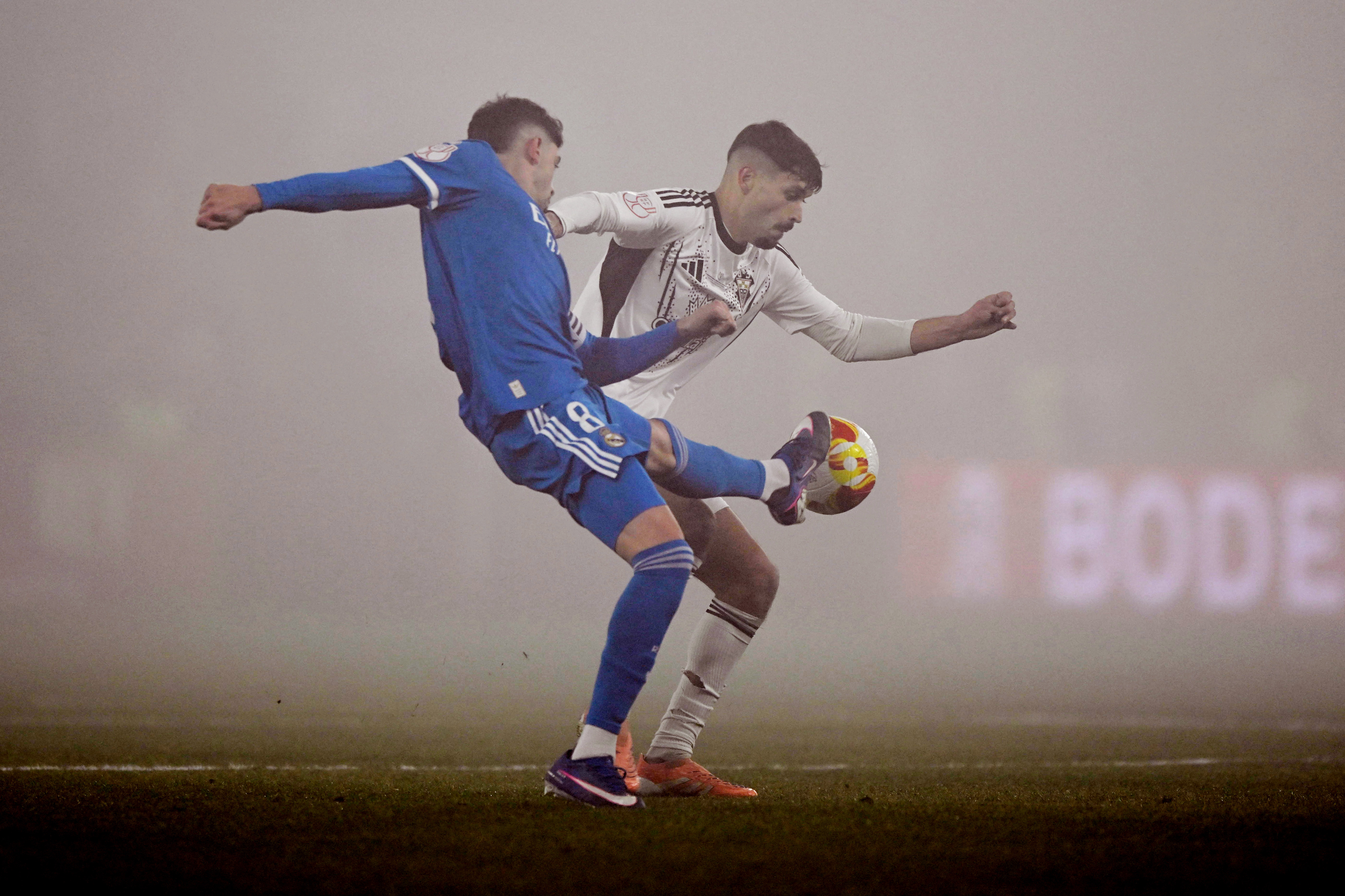 Soccer Football - Copa del Rey - Round of 16 - Albacete v Real Madrid - Estadio Carlos Belmonte, Albacete, Spain - January 14, 2026 Real Madrid's Federico Valverde in action with Albacete's Antonio Pacheco REUTERS/Pablo Morano