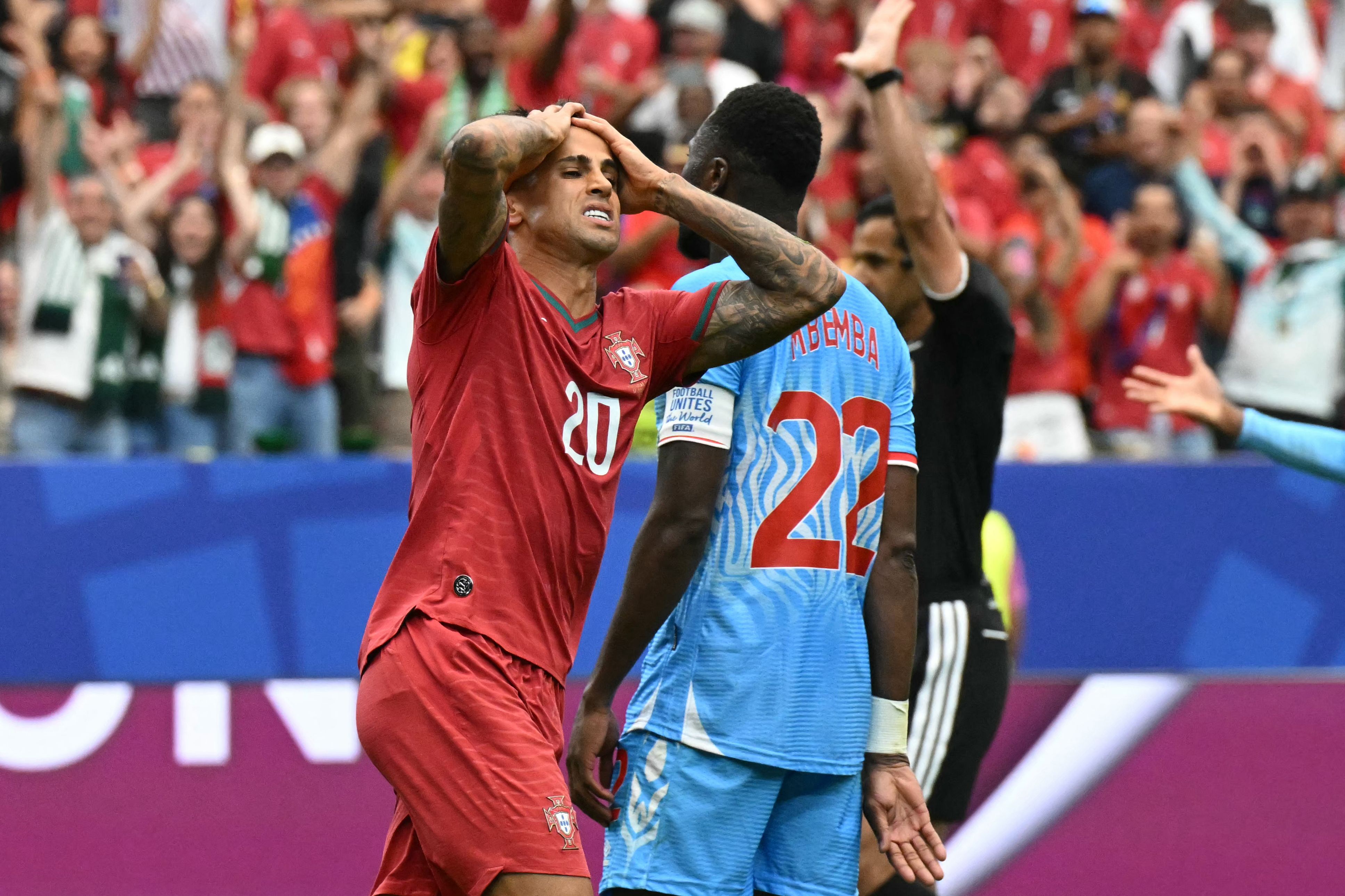 Portugal's defender #20 Joao Cancelo (L) reacts after missing a goal opportunity during the 2026 World Cup Group K football match between Portugal and the Democratic Republic of Congo at the Houston Stadium in Houston on June 17, 2026. (Photo by RONALDO SCHEMIDT / AFP)