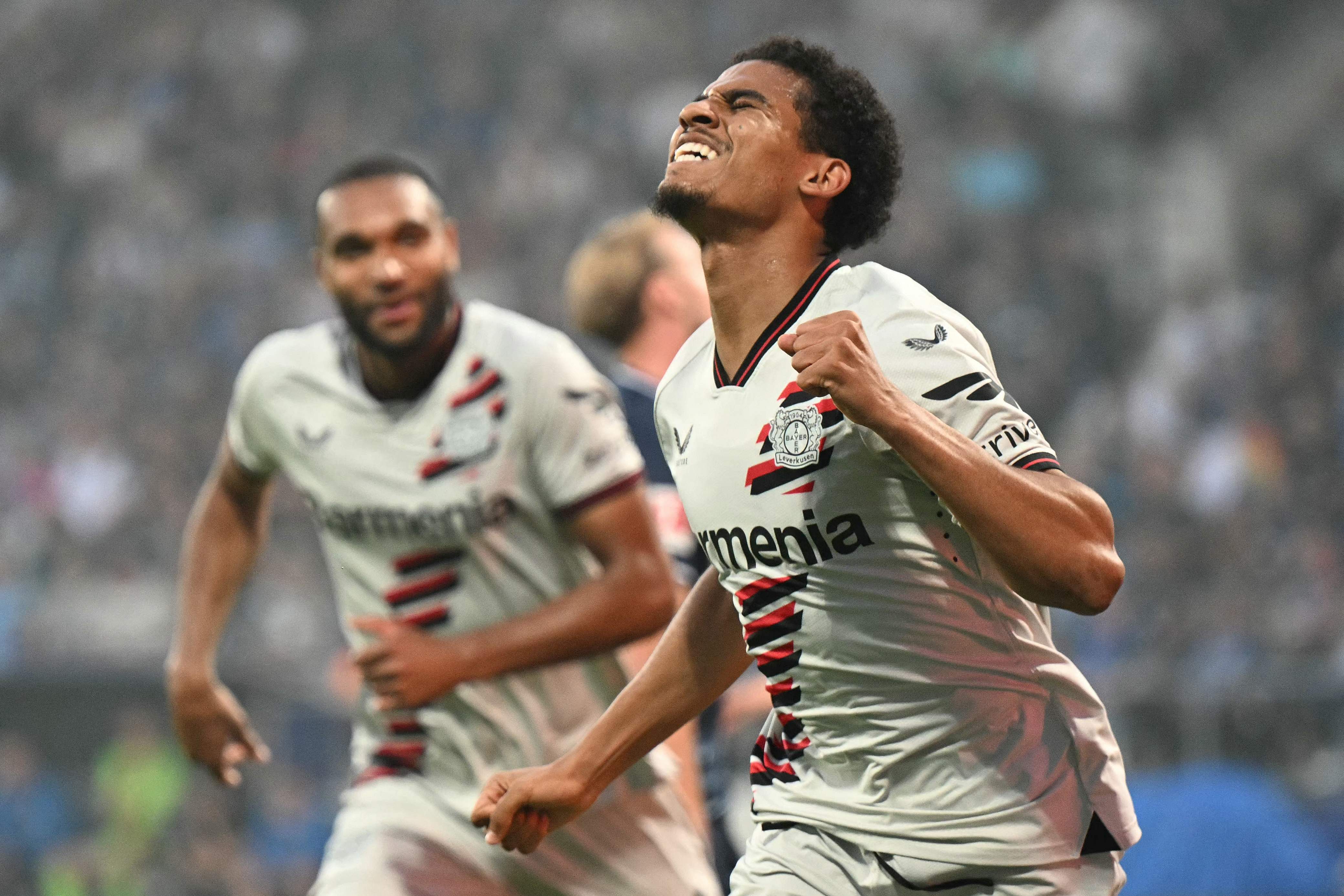 Bayer Leverkusen's French forward #21 Amine Adli celebrates scoring the 0-3 goal with his team-mates during the German first division Bundesliga football match between VfL Bochum and Bayer 04 Leverkusen in Bochum, western Germany on May 12, 2024. (Photo by INA FASSBENDER / AFP) / DFL REGULATIONS PROHIBIT ANY USE OF PHOTOGRAPHS AS IMAGE SEQUENCES AND/OR QUASI-VIDEO