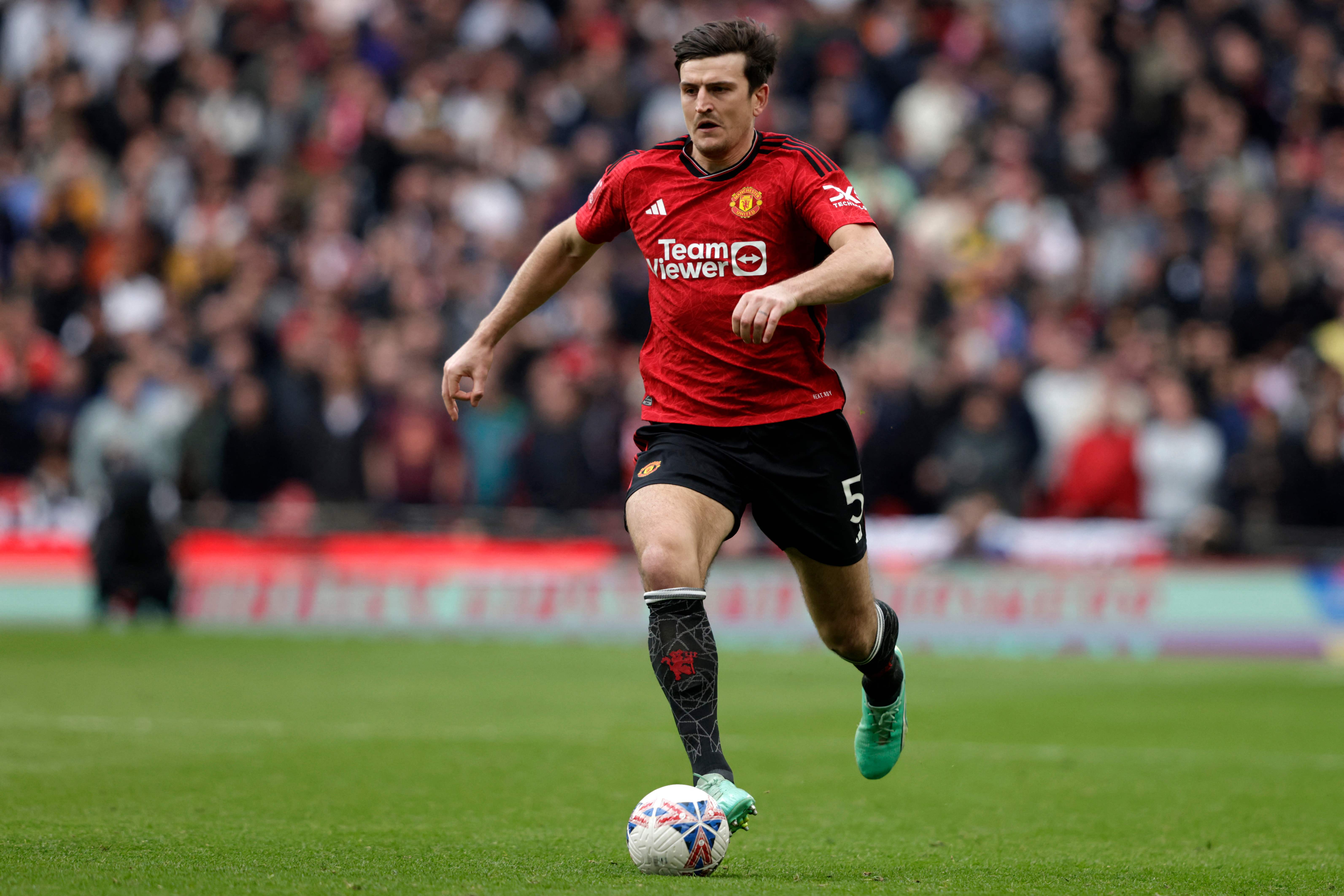 Manchester United's English defender #05 Harry Maguire runs with the ball during the English FA Cup semi-final football match between Coventry City and Manchester United at Wembley Stadium in north west London on April 21, 2024. (Photo by Ian Kington / AFP) / NOT FOR MARKETING OR ADVERTISING USE / RESTRICTED TO EDITORIAL USE