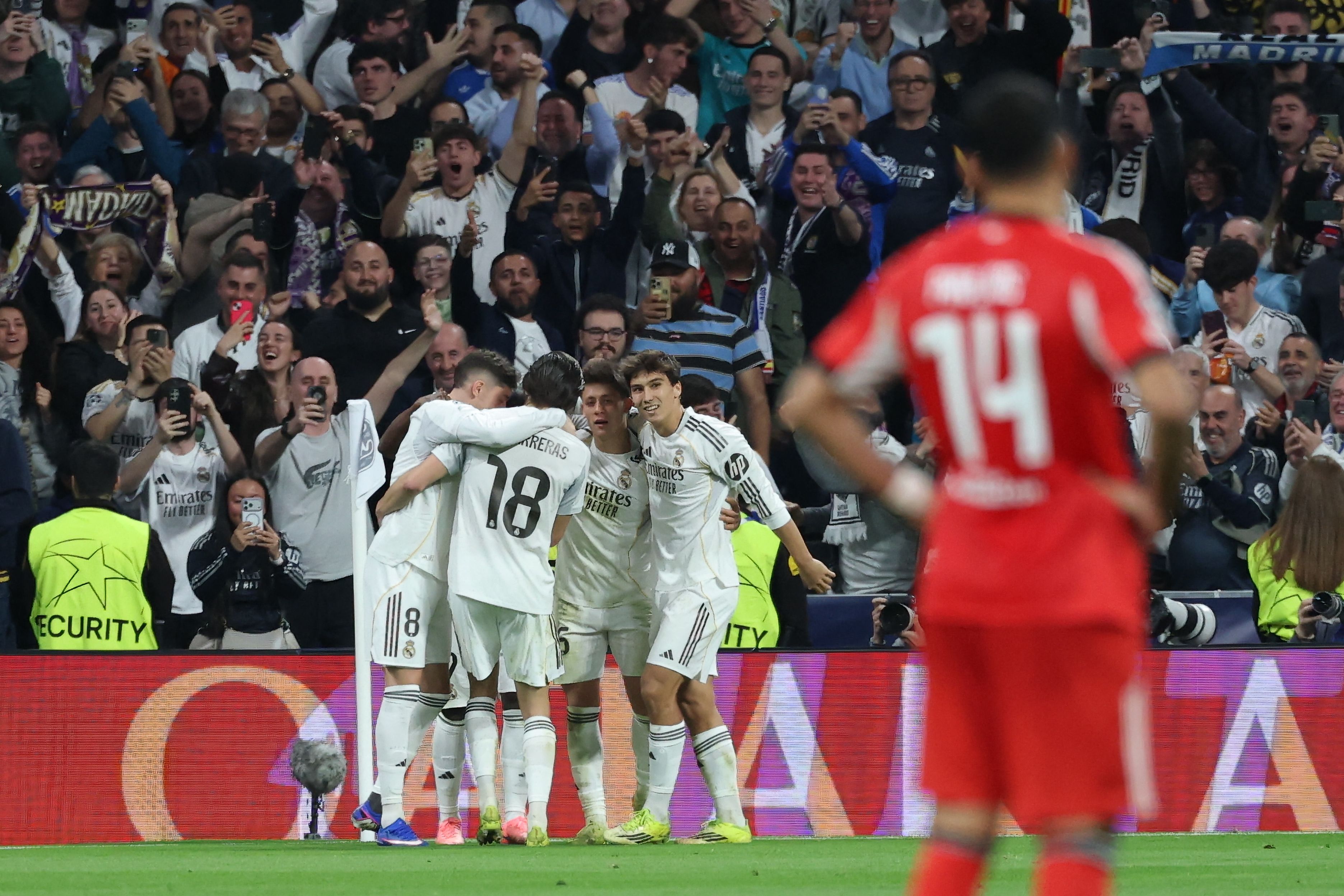 Real Madrid players celebrate their second goal scored by Real Madrid's Brazilian forward #07 Vinicius Junior during the UEFA Champions League knockout round play-off second leg football match between Real Madrid CF and SL Benfica at Santiago Bernabeu Stadium in Madrid on February 25, 2026. (Photo by Thomas COEX / AFP)