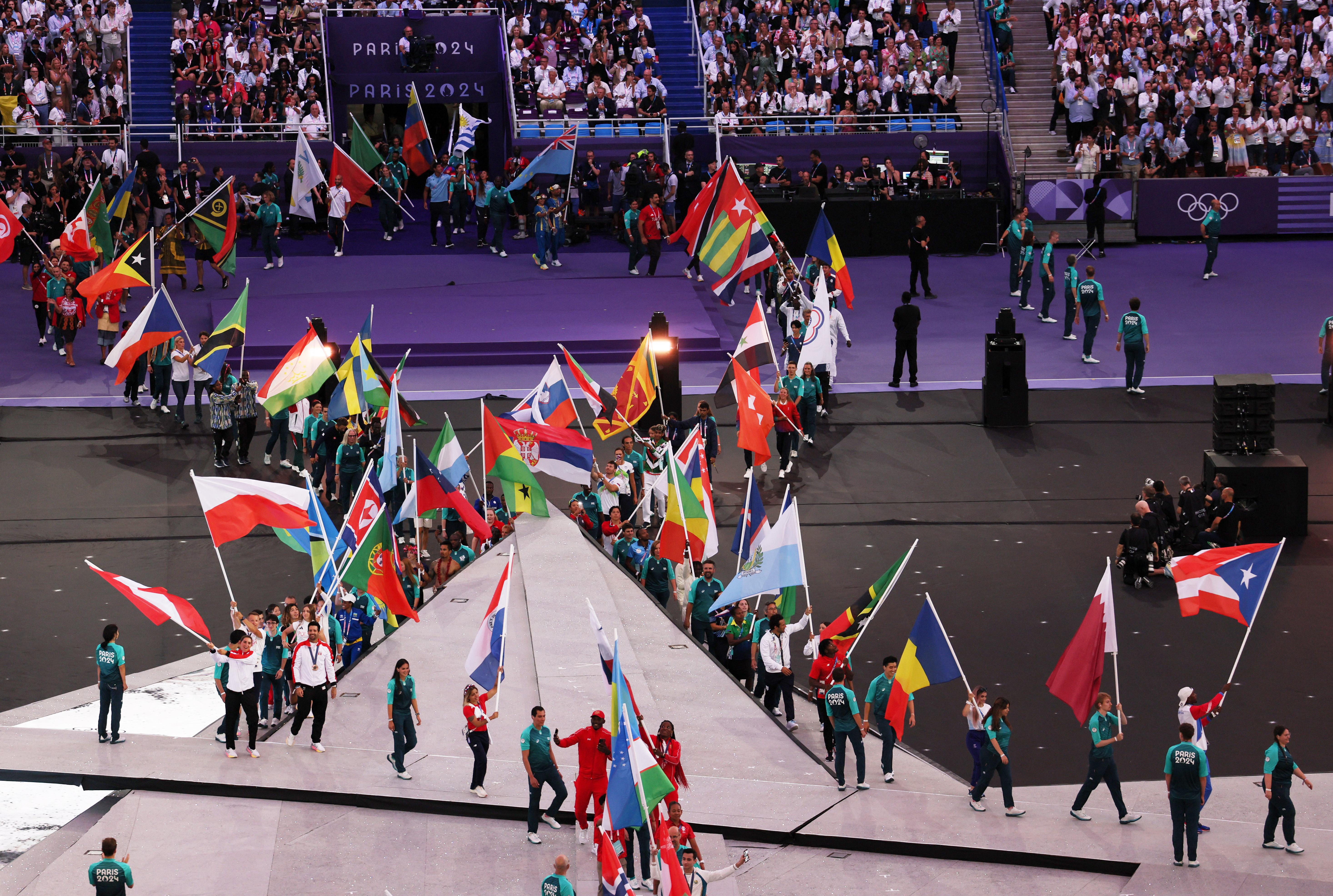 Paris 2024 Olympics - Ceremonies - Paris 2024 Closing Ceremony - Stade de France, Saint-Denis, France - August 11, 2024. Flagbearers carry flags during the closing ceremony. REUTERS/Leah Millis