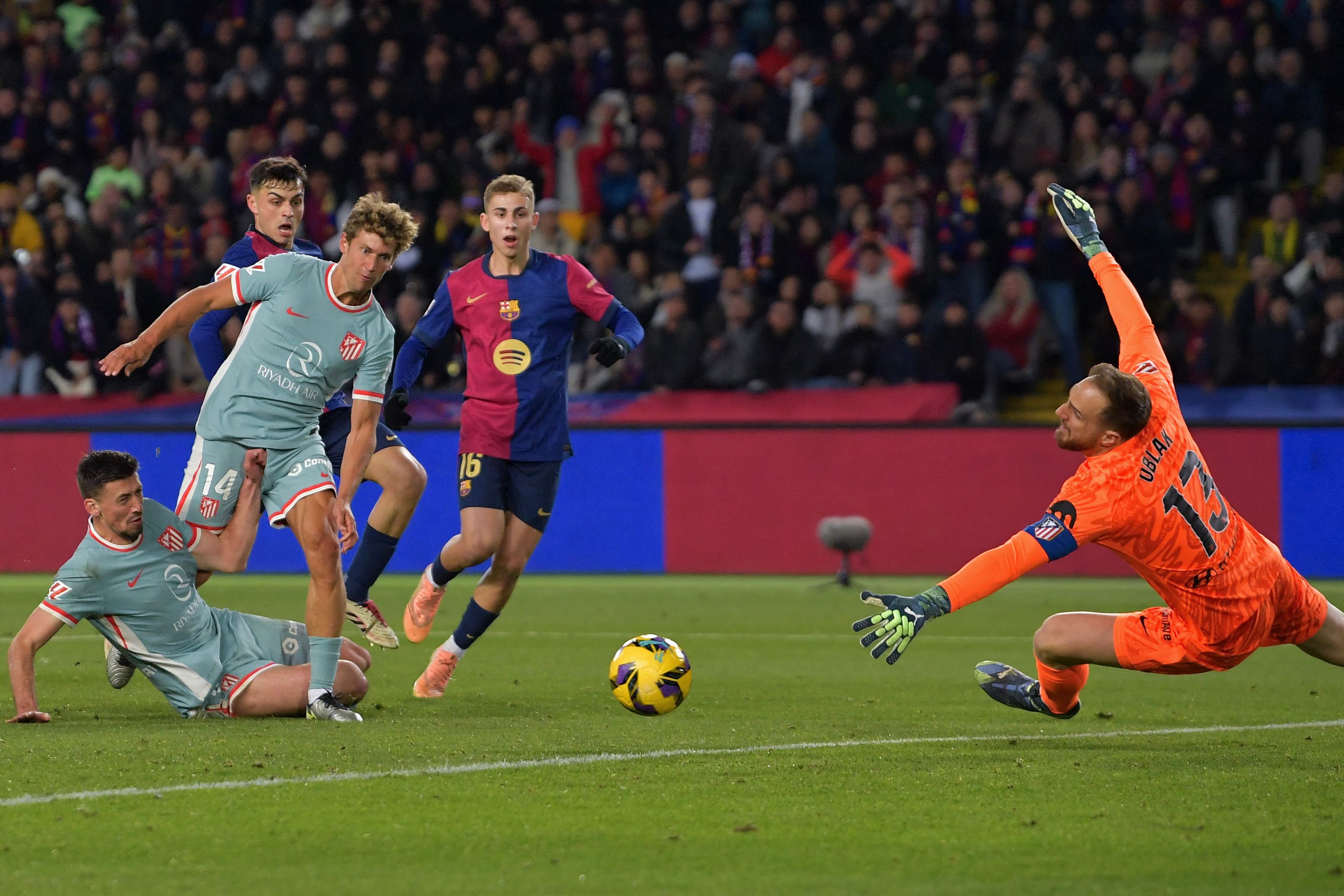 Barcelona's Spanish midfielder #08 Pedri (2L) scores their first goal during the Spanish league football match between FC Barcelona and Club Atletico de Madrid at the Estadi Olimpic Lluis Companys in Barcelona on December 21, 2024. (Photo by MANAURE QUINTERO / AFP)