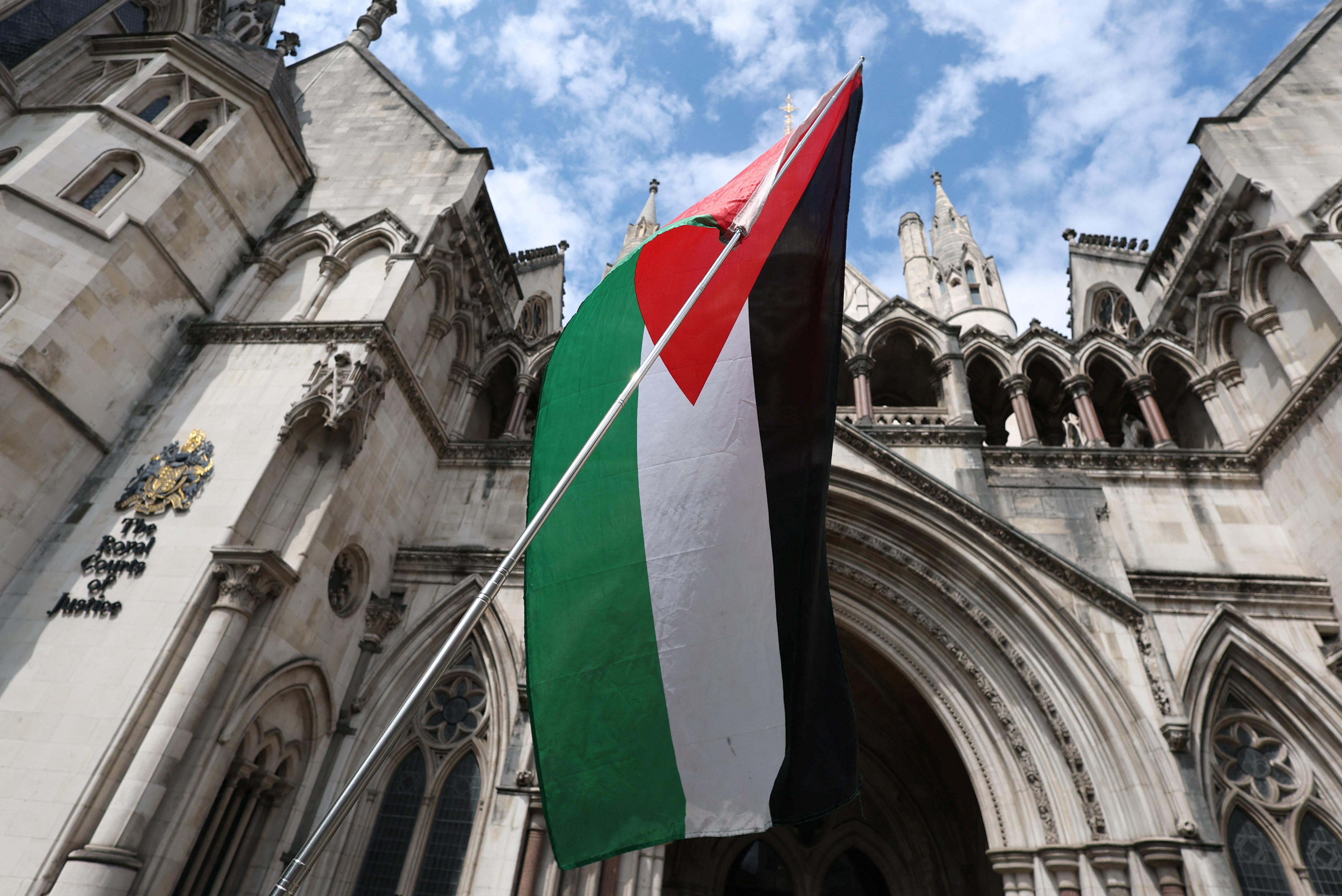 A Palestinian flag is seen, outside London's High Court as judges decide whether the co-founder of Palestine Action can challenge the UK government's ban on the group, in London, Britain, July 30, 2025. REUTERS/Toby Melville