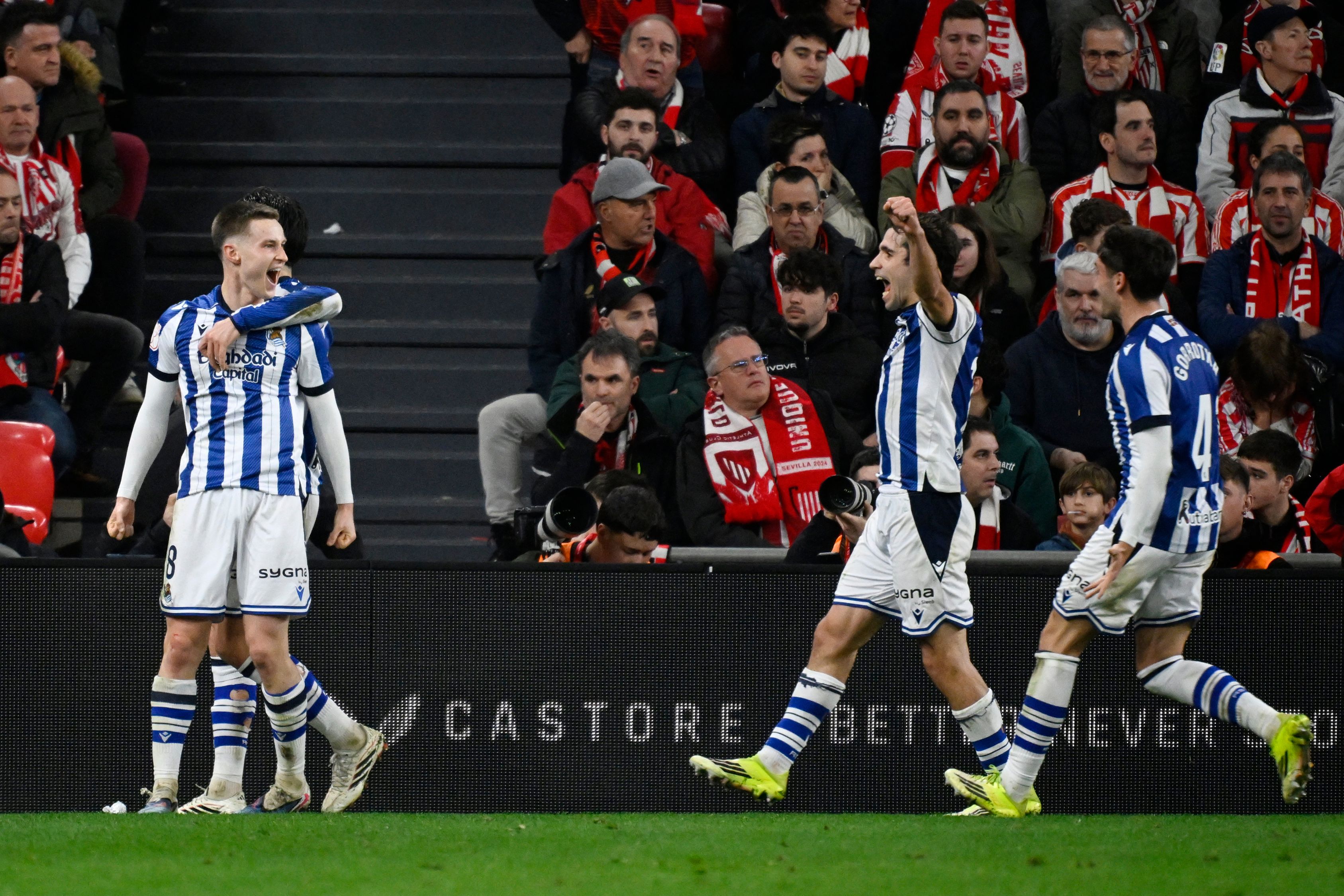Real Sociedad's Spanish midfielder #08 Benat Turrientes (L) celebrates scoring the opening goal during the Spanish Copa del Rey (King's Cup) semi final first leg football match between Athletic Club Bilbao and Real Sociedad at San Mames Stadium in Bilbao on February 11, 2026. (Photo by ANDER GILLENEA / AFP)